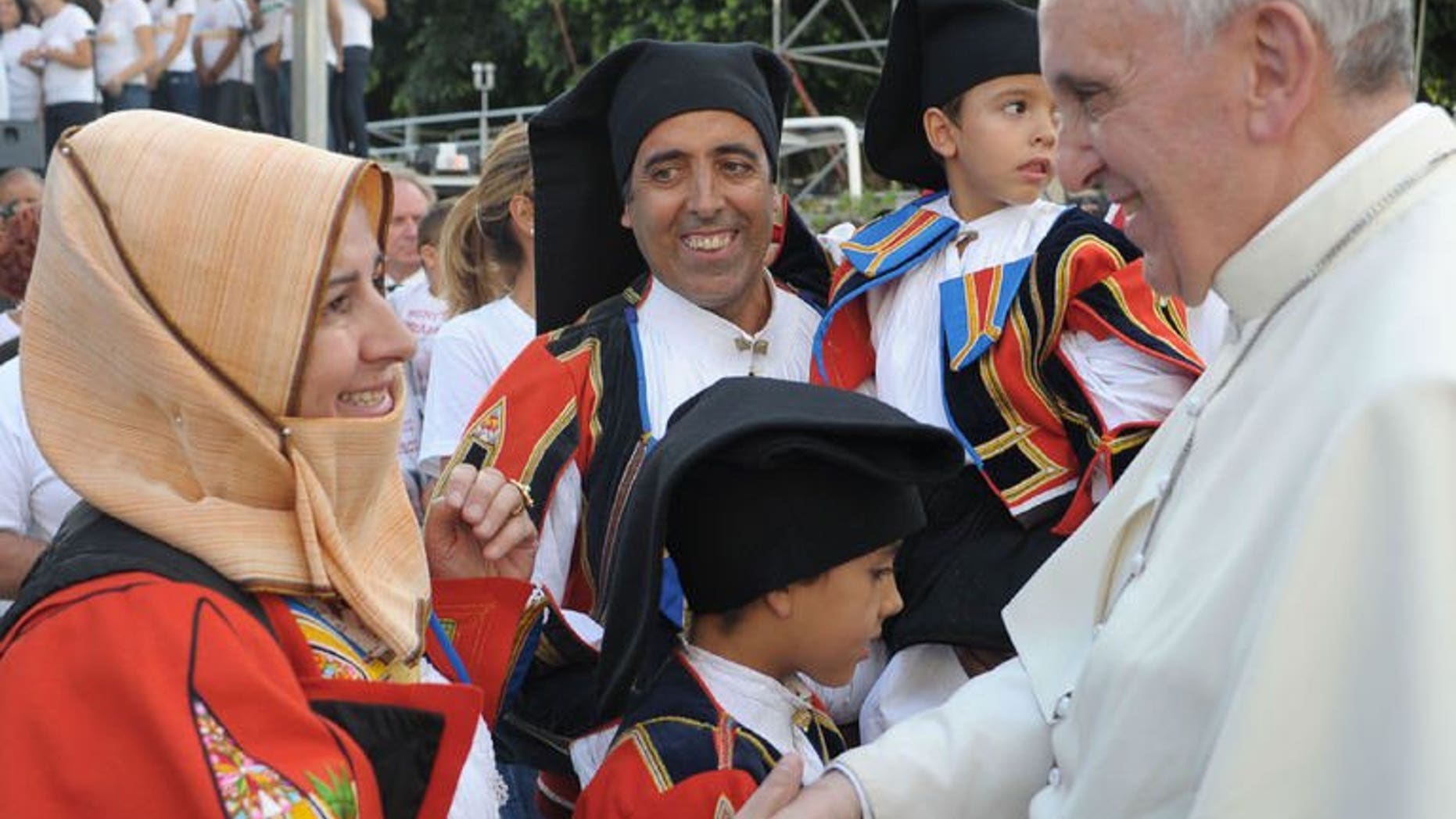 Pope Francis meets worshippers during a visit to Cagliari, on September 22, 2013. Pope Francis has called on countries to protect migrants, condemning the treatment of refugees as mere "pawns on the chessboard of humanity".