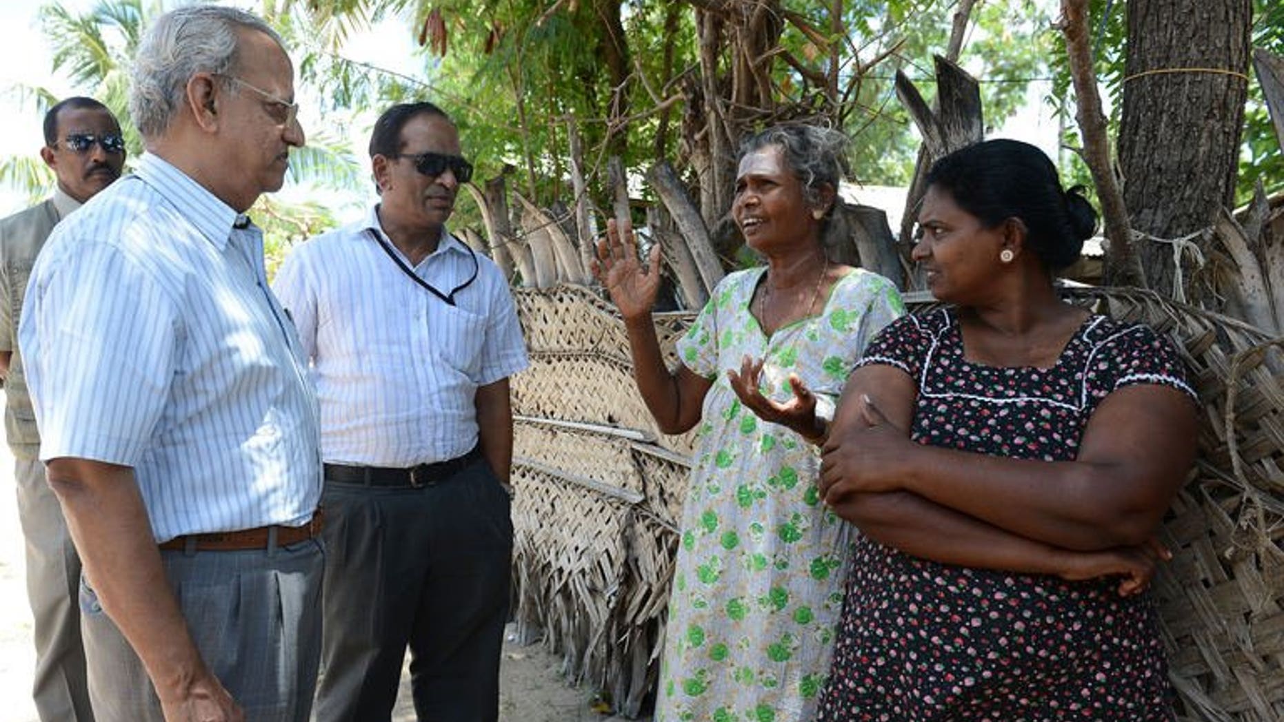 Foreign observers speak with Sri Lankan Tamil residents at The Kanniamman Welfare Centre at the country's northern most tip of Point Pedro on September 19, 2013.