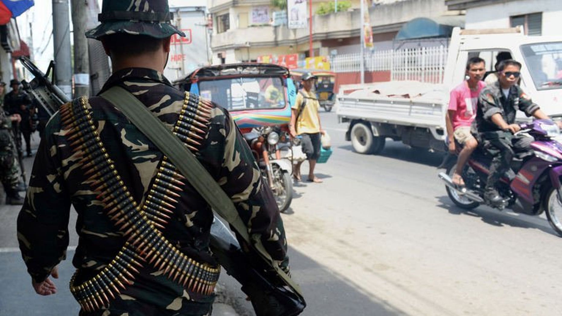 Philippine soldiers patrol the streets as government forces clash anew with remnants of Muslim rebels in Zamboanga City, on southern island of Mindanao on September 21, 2013.
