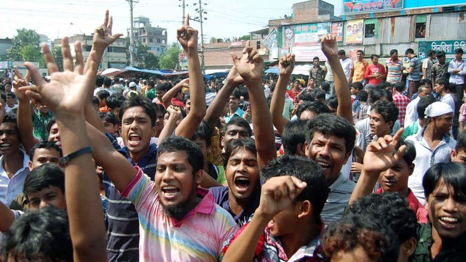 Bangladeshi garment workers shout slogans during a protest in Narayanganj on September 24, 2013.