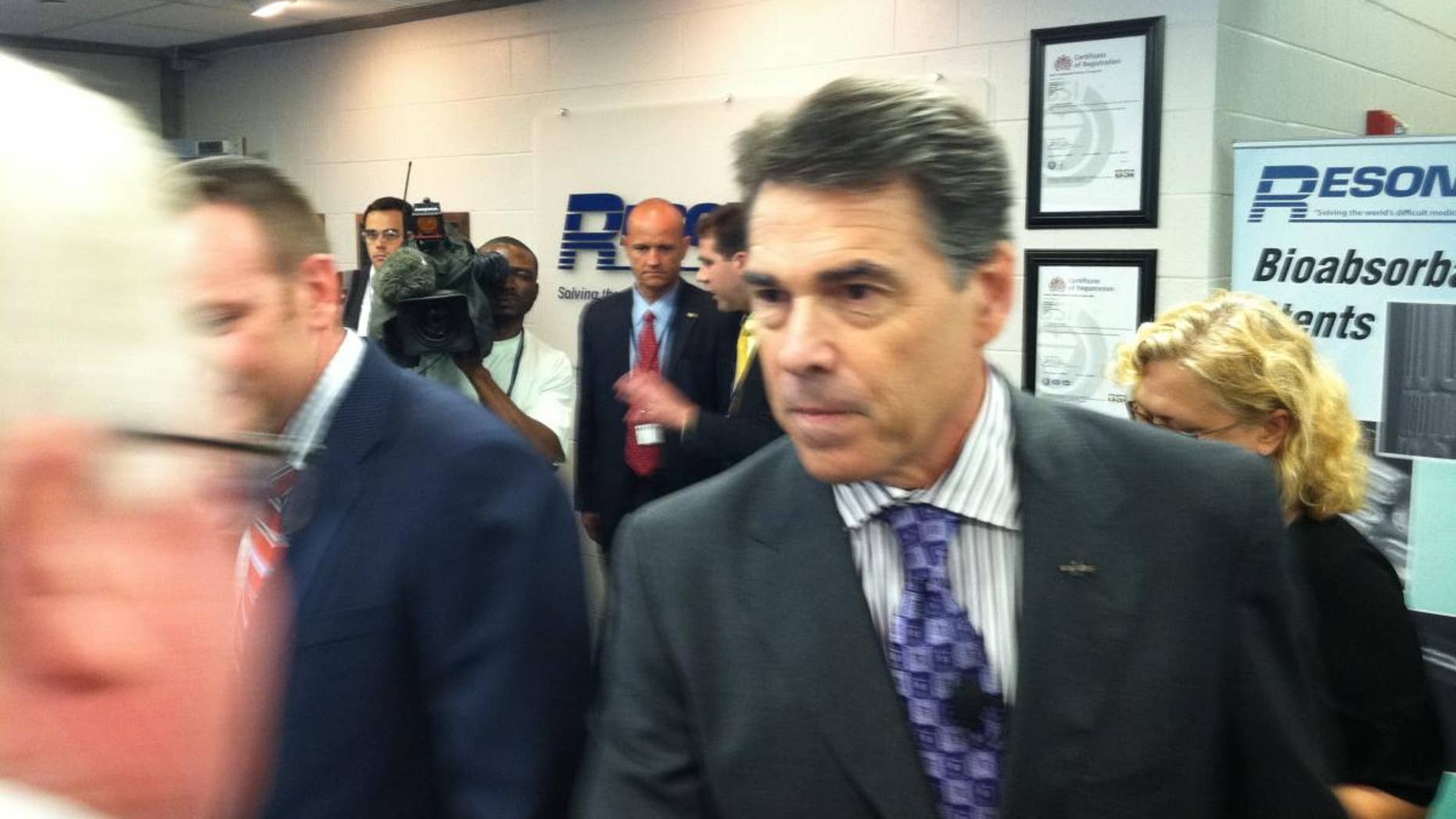 Rick Perry greets participants at an economic roundtable in Nashua, NH on Wednesday