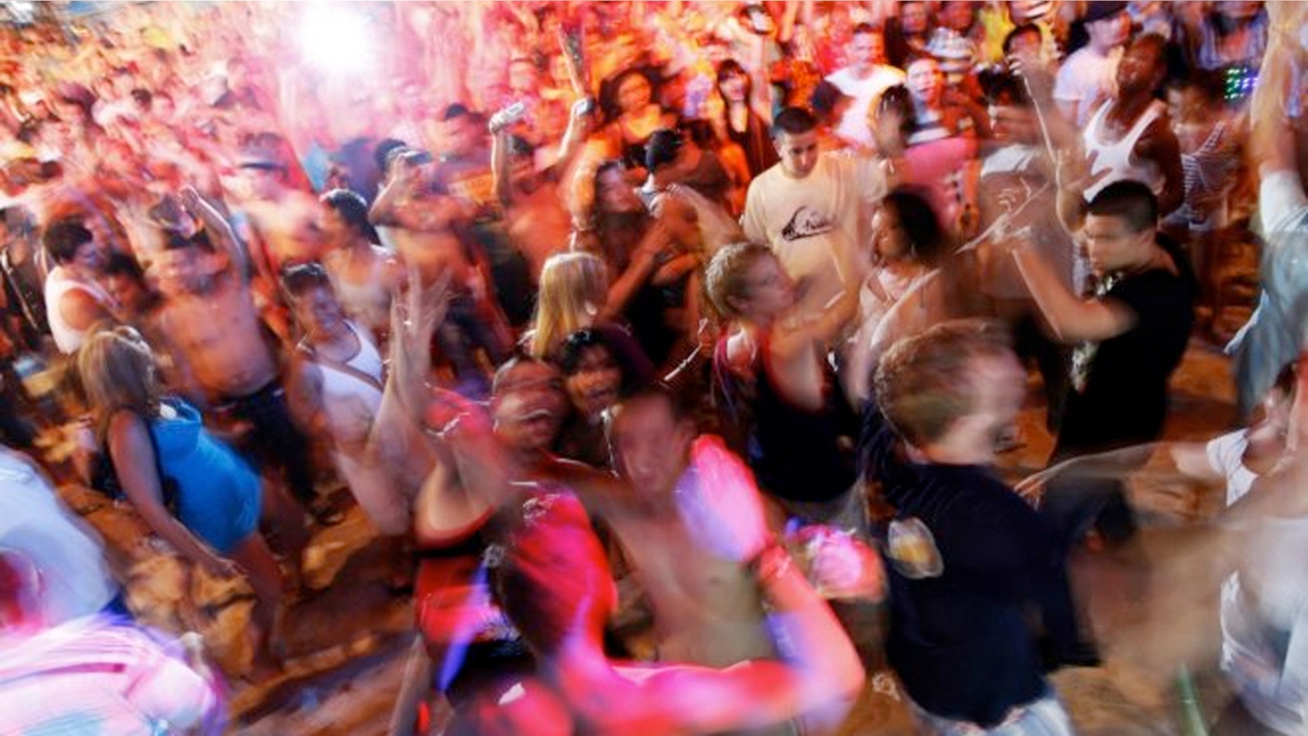 Tourists dance to electronic music during an open-air party at Patong beach in Phuket, one of Asia's premier resort islands. (Reuters)
