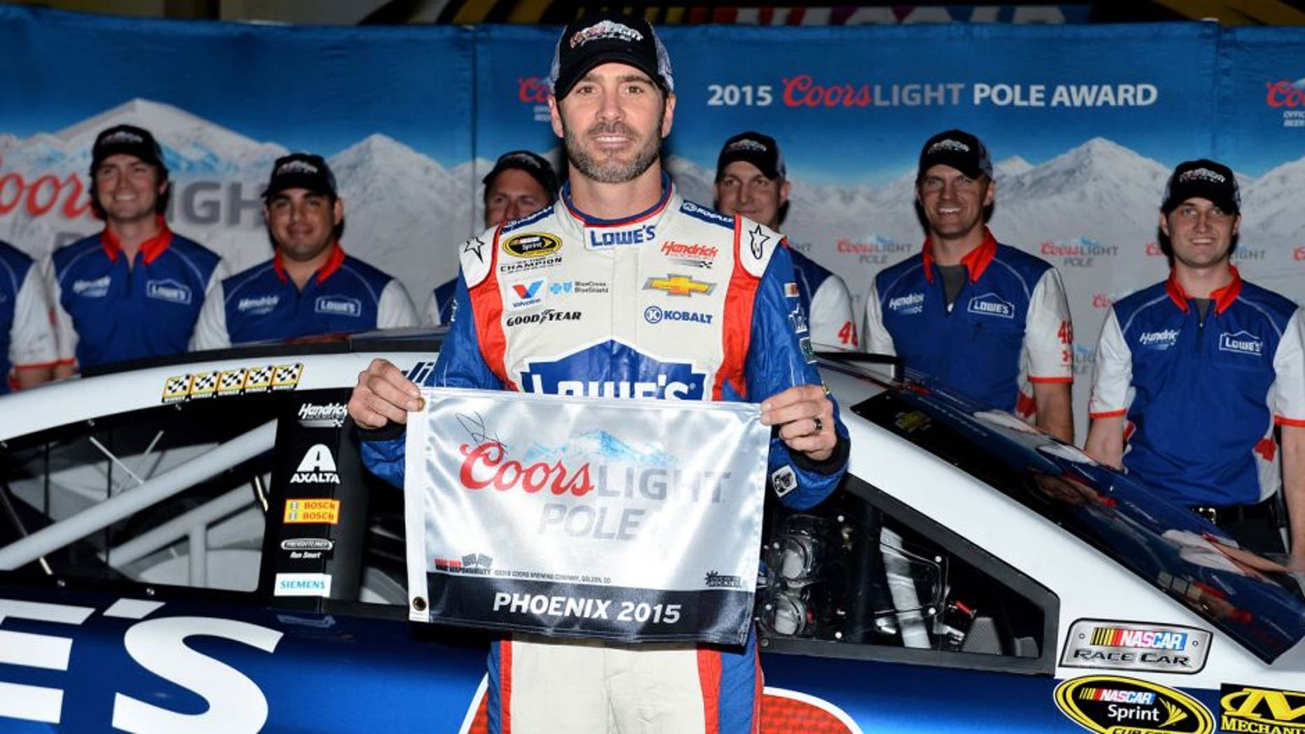Nov 13, 2015; Avondale, AZ, USA; NASCAR Sprint Cup Series driver Jimmie Johnson poses for a picture after winning the pole for the Quicken Loans Race For Heroes 500 at Phoenix International Raceway. Mandatory Credit: Jasen Vinlove-USA TODAY Sports