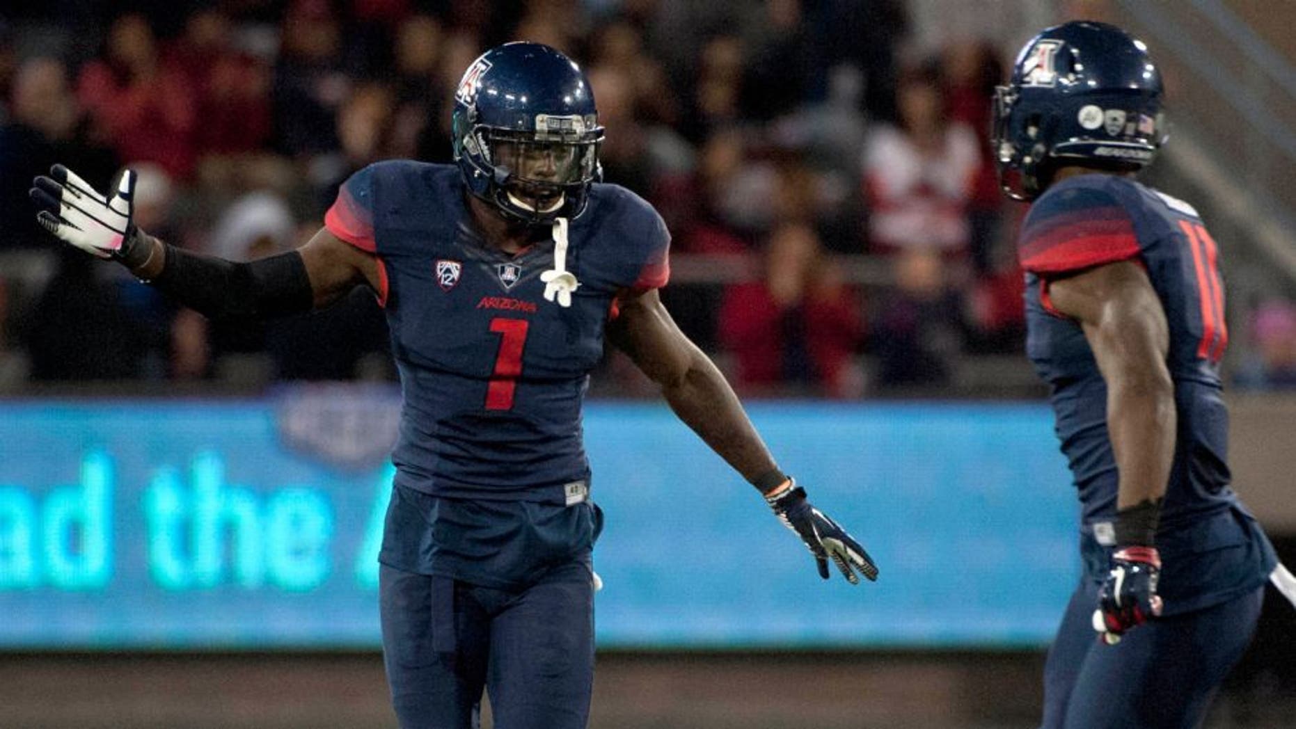 Nov 14, 2015; Tucson, AZ, USA; Arizona Wildcats safety Tellas Jones (1) and safety Will Parks (11) celebrate after a fumble recovery during the fourth quarter against the Utah Utes at Arizona Stadium. Arizona won 37-30 in double overtime. Mandatory Credit: Casey Sapio-USA TODAY Sports