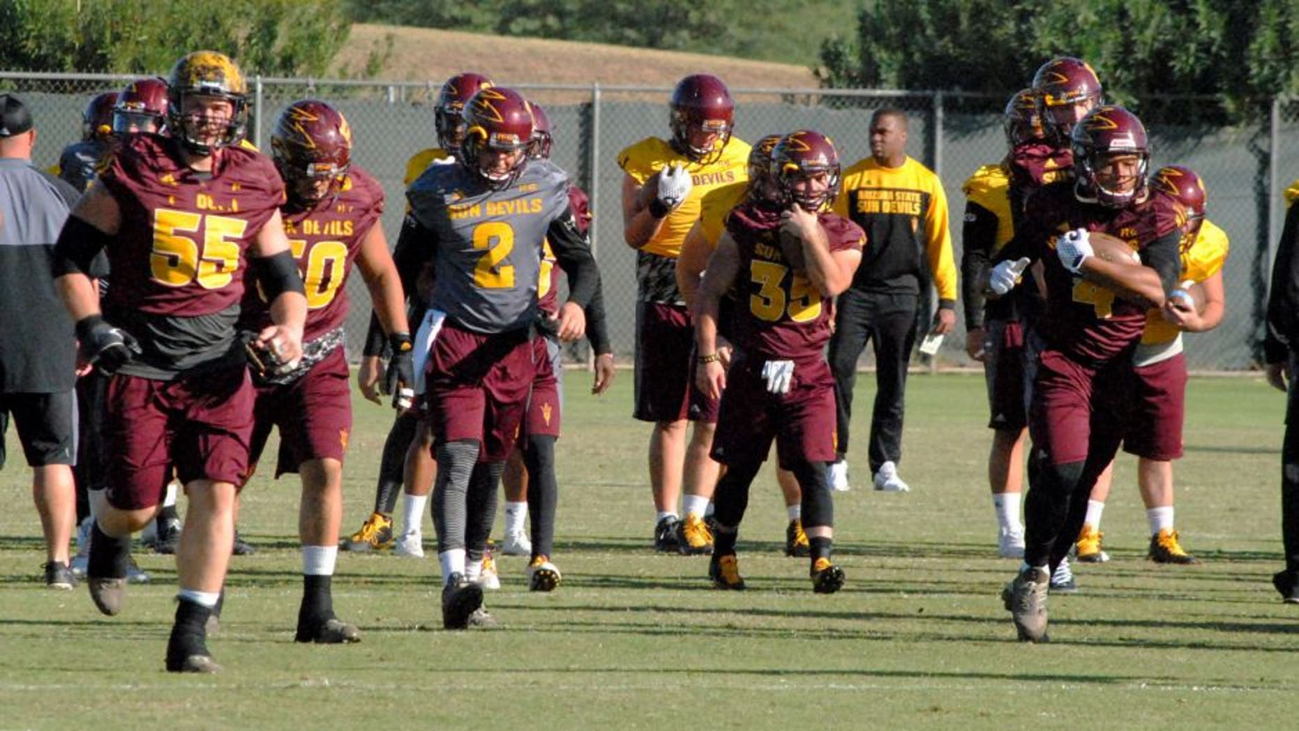 ASU QB Mike Bercovici goes through stretching lines with the team prior to the Sun Devilsâ last practice before hosting the Oregon Ducks Thursday.