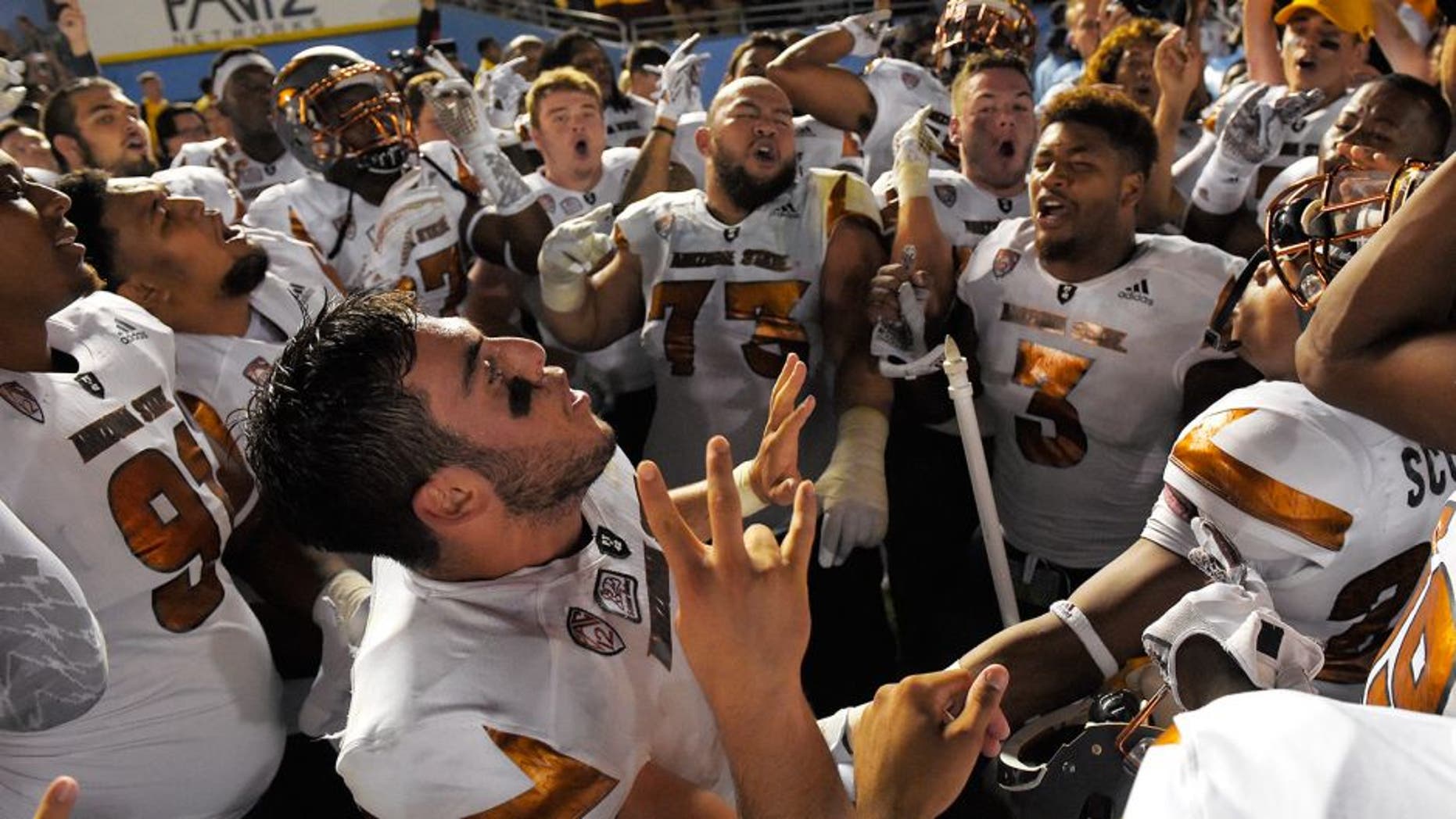 Arizona State quarterback Mike Bercovici, below, celebrates with teammate after they defeated UCLA in an NCAA college football game, Saturday, Oct. 3, 2015, in Pasadena, Calif. Arizona State won 38-23. (AP Photo/Mark J. Terrill)