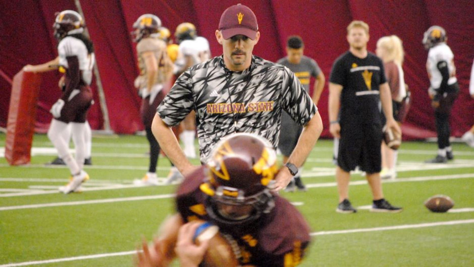 ASU offensive coordinator Mike Norvell watches the running backs in ball protection drill inside the Verde Dickey Dome on October 6, 2015 in Tempe.