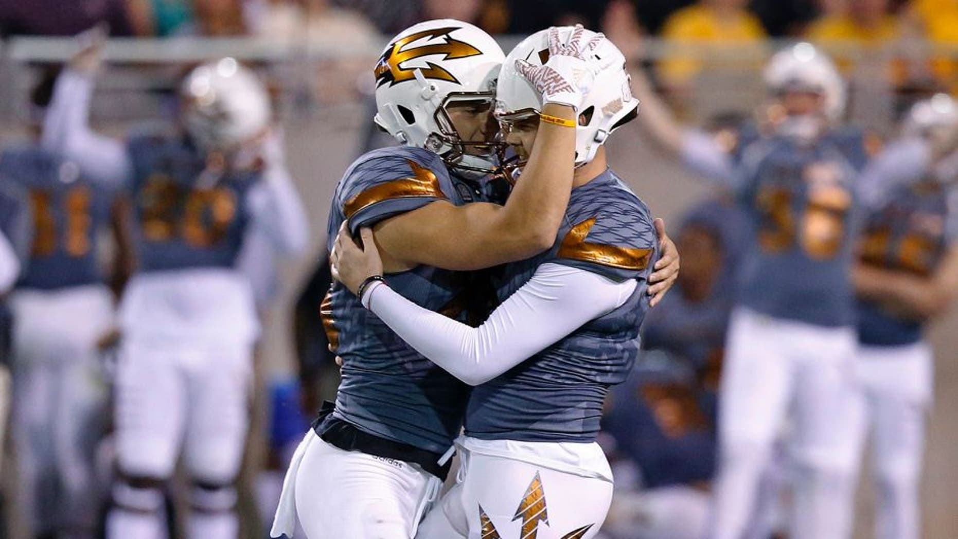 Arizona State's Zane Gonzalez, right, gets a hug from holder Matt Haack after Gonzalez connected for a field goal during the second half of an NCAA college football game against UCLA on Saturday, Oct. 8, 2016, in Tempe, Ariz. Gonzalez kicked three field goals to become the NCAA's all-time leader with 89. Arizona State defeated UCLA 23-20. (AP Photo/Ross D. Franklin)