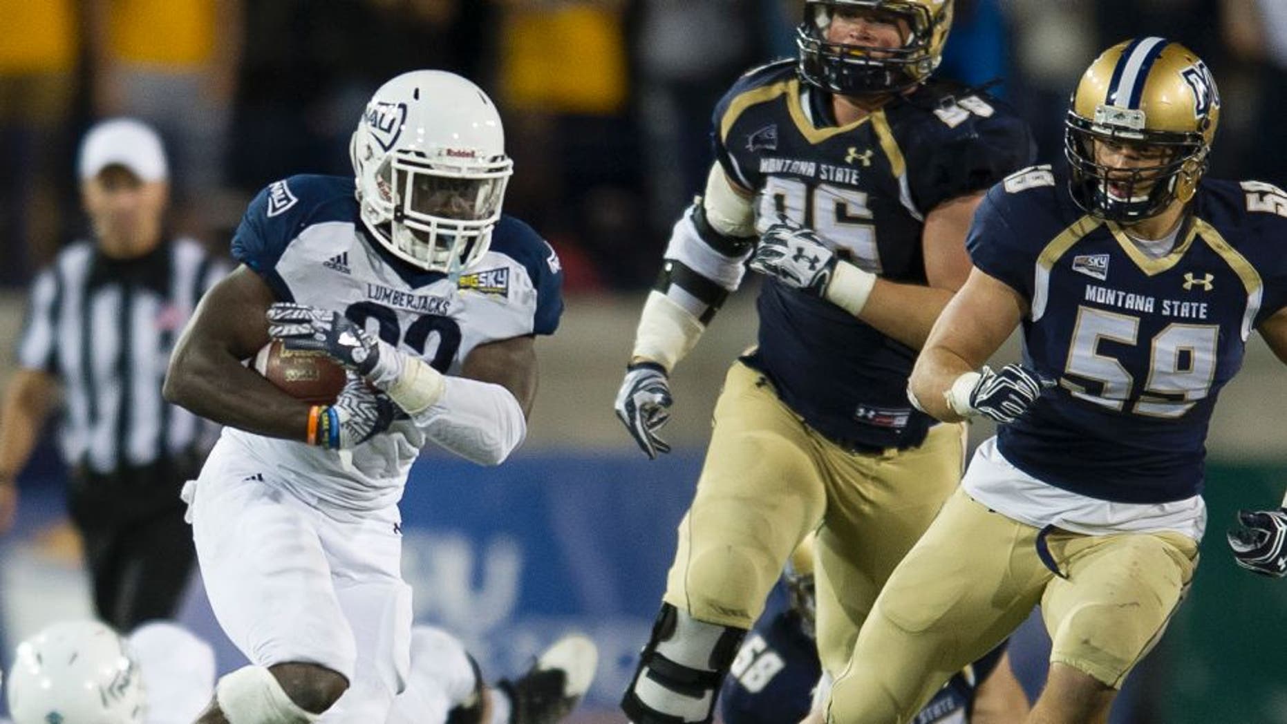 In this photo provided by Montana State University, Northern Arizona running back Joe Logan (22) gains yards during the second half of an NCAA college football game against Northern Arizona on Saturday, Oct. 8, 2016 in Bozeman, Mont. Northern Arizona won 20-14. (Kelly Gorham/Montana State University via AP)