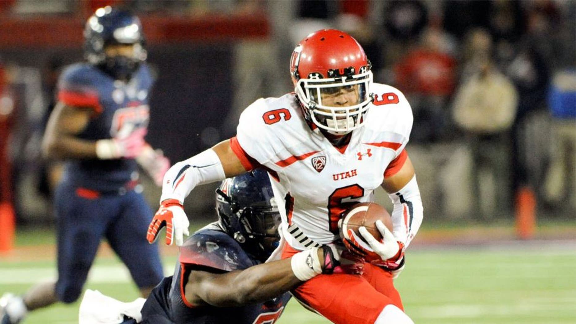 Oct 19, 2013; Tucson, AZ, USA; Utah Utes wide receiver Dres Anderson (6) is tackled by Arizona Wildcats linebacker Marquis Flowers (2) during the fourth quarter at Arizona Stadium. Arizona beat Utah 35-44. Mandatory Credit: Casey Sapio-USA TODAY Sports