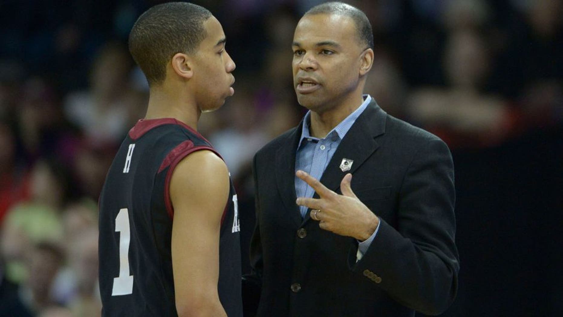 Mar 20, 2014; Spokane, WA, USA; Harvard Crimson head coach Tommy Amaker (right) instructs guard Siyani Chambers (1) against the Cincinnati Bearcats in the first half of a men's college basketball game during the second round of the 2014 NCAA Tournament at Veterans Memorial Arena. Mandatory Credit: Kirby Lee-USA TODAY Sports