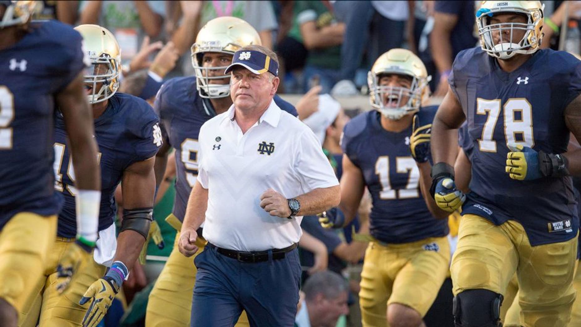 Sep 5, 2015; South Bend, IN, USA; Notre Dame Fighting Irish head coach Brian Kelly runs onto the field before the game against the Texas Longhorns at Notre Dame Stadium. Notre Dame won 38-3. Mandatory Credit: Matt Cashore-USA TODAY Sports