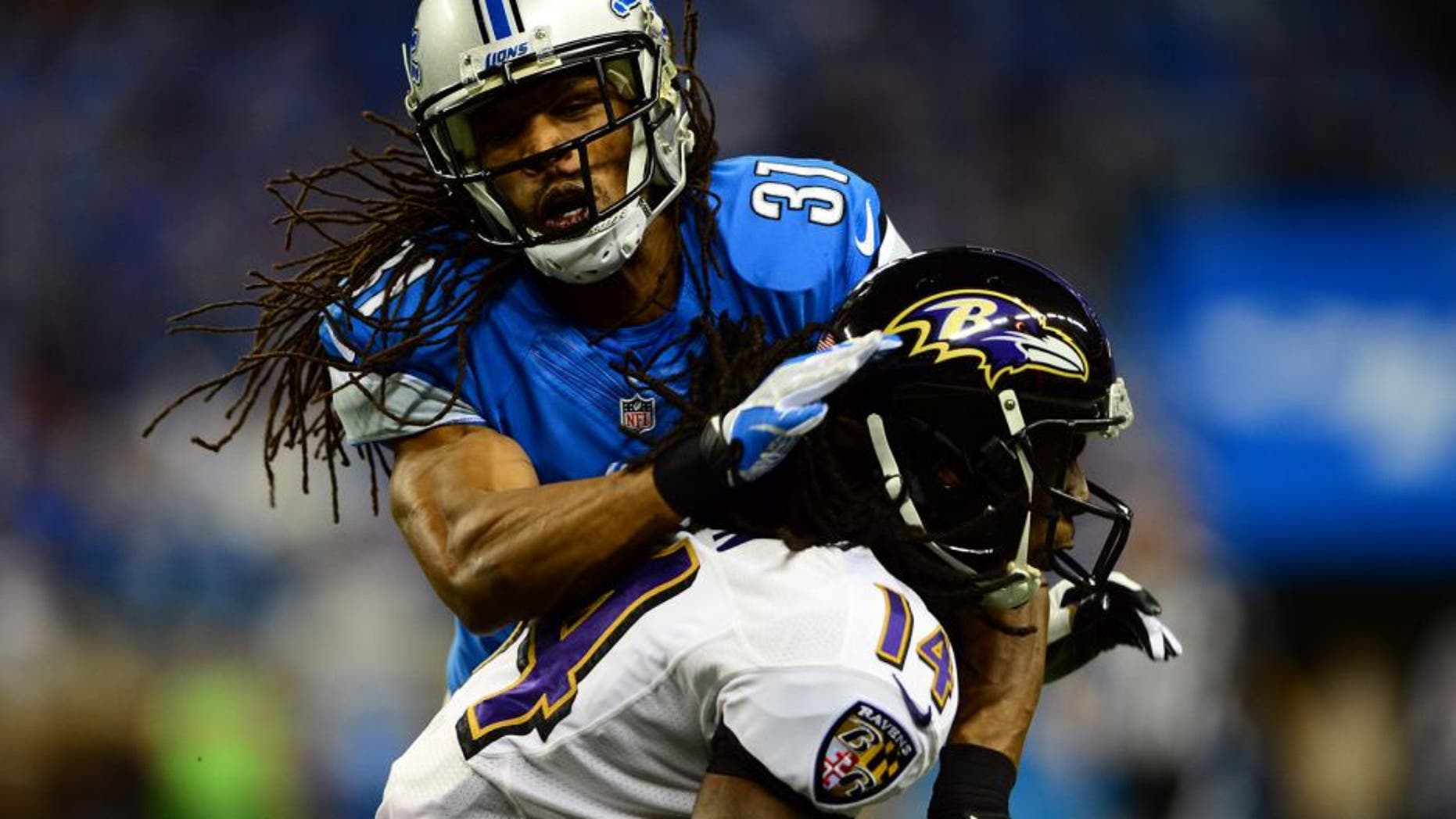Dec 16, 2013; Detroit, MI, USA; Detroit Lions cornerback Rashean Mathis (31) tackles by Baltimore Ravens wide receiver Marlon Brown (14) during the second quarter at Ford Field. Mandatory Credit: Andrew Weber-USA TODAY Sports