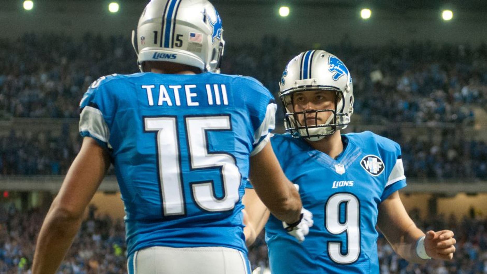 Dec 14, 2014; Detroit, MI, USA; Detroit Lions wide receiver Golden Tate (15) celebrates his touchdown with quarterback Matthew Stafford (9) during the second quarter against the Minnesota Vikings at Ford Field. Mandatory Credit: Tim Fuller-USA TODAY Sports