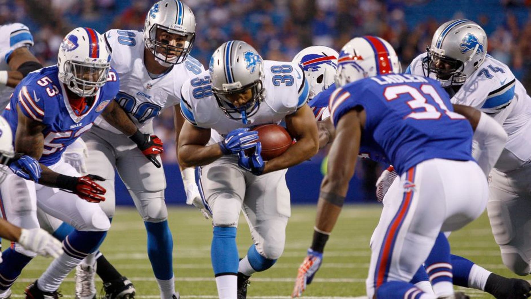 Aug 28, 2014; Orchard Park, NY, USA; Detroit Lions running back George Winn (38) runs the ball during the first half against the Buffalo Bills at Ralph Wilson Stadium. Mandatory Credit: Timothy T. Ludwig-USA TODAY Sports