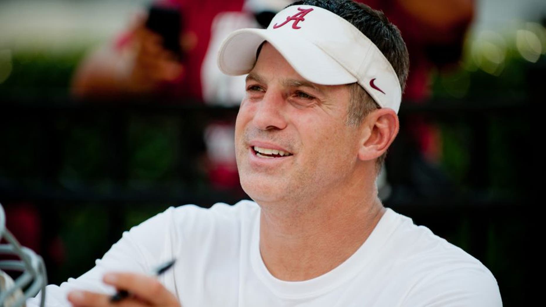 Aug 4, 2013; Tuscaloosa, AL, USA; Alabama Crimson Tide defensive coordinator Doug Nussmeier signs autographs following practice at Bryant Denny Stadium. Mandatory Credit: Kevin Liles-USA TODAY Sports