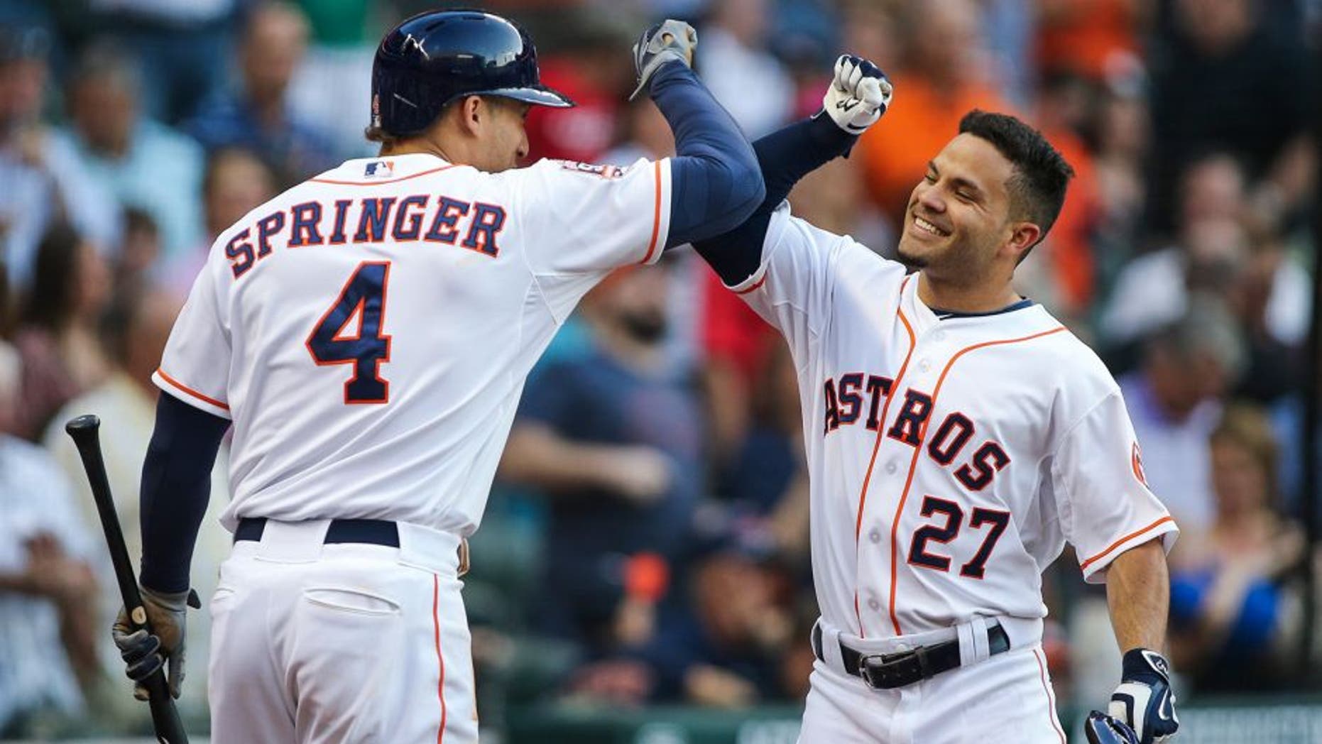 May 2, 2015; Houston, TX, USA; Houston Astros second baseman Jose Altuve (27) celebrates with right fielder George Springer (4) after hitting a home run during the fourth inning against the Seattle Mariners at Minute Maid Park. Mandatory Credit: Troy Taormina-USA TODAY Sports