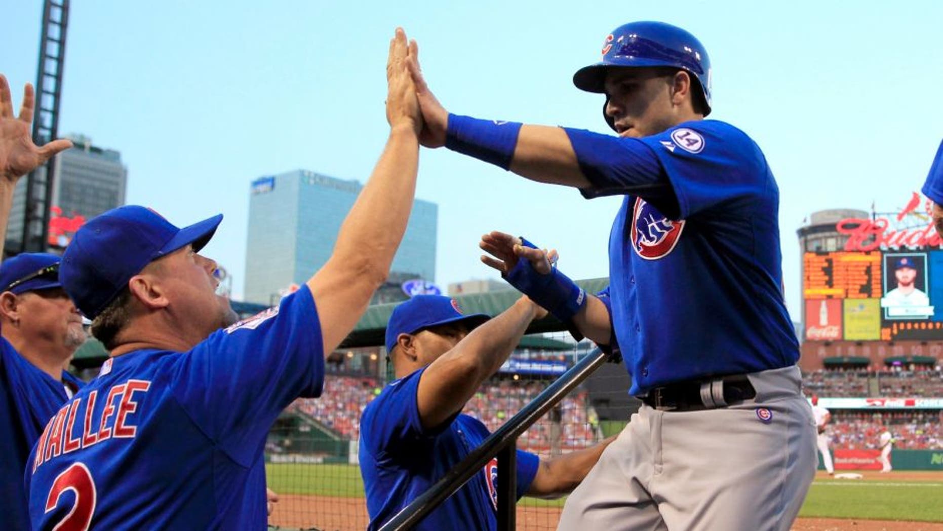 Chicago Cubs' Miguel Montero, right, is congratulated by hitting coach John Mallee, left, after scoring during the first inning of a baseball game against the St. Louis Cardinals, Monday, May 4, 2015, in St. Louis. (AP Photo/Jeff Roberson)