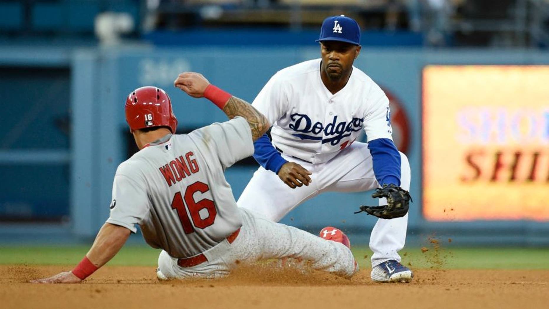 Jun 5, 2015; Los Angeles, CA, USA; St. Louis Cardinals second baseman Kolten Wong (16) is tagged out by Los Angeles Dodgers shortstop Jimmy Rollins (11) in the third inning during the game at Dodger Stadium. Mandatory Credit: Richard Mackson-USA TODAY Sports