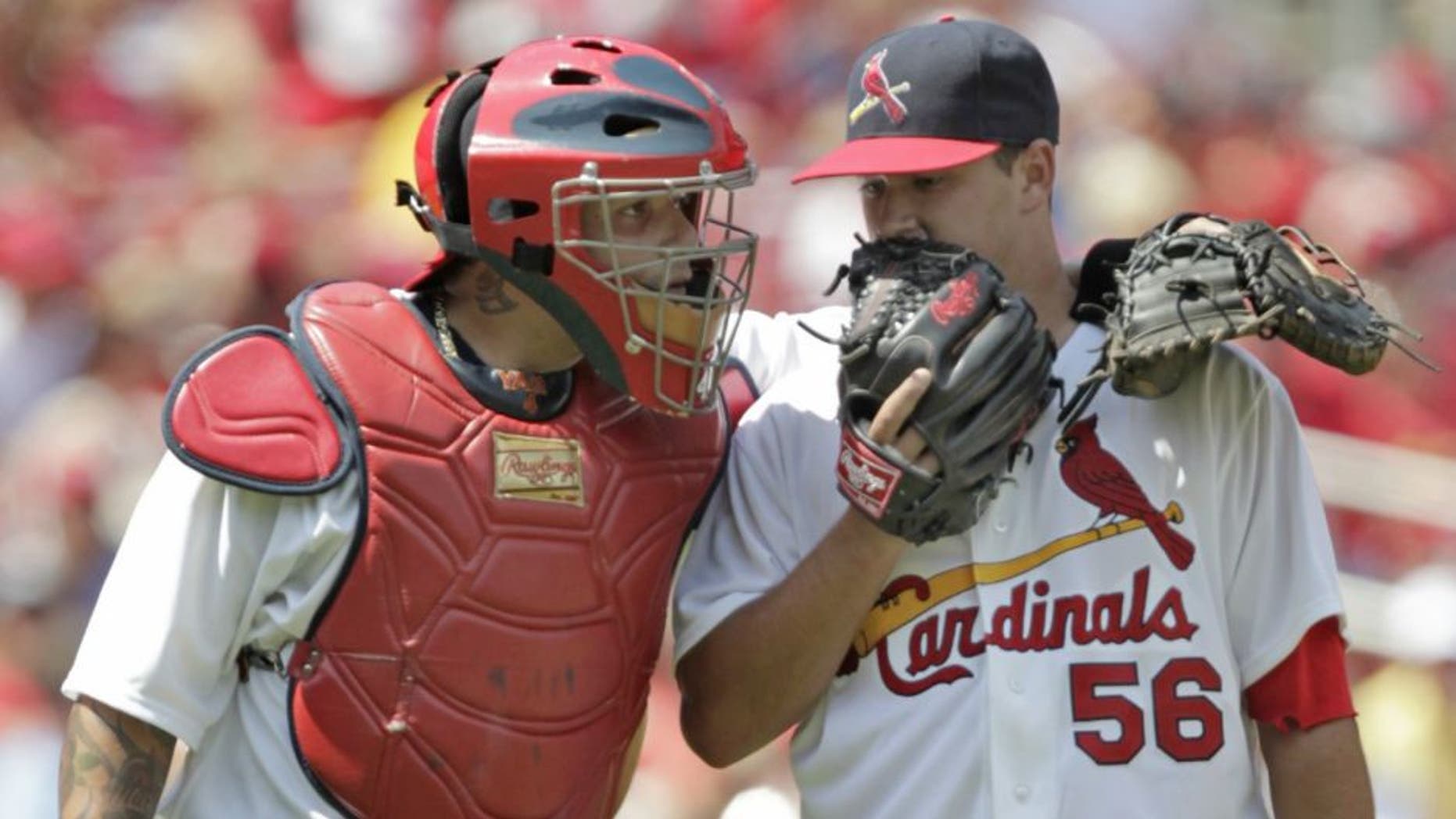 St. Louis Cardinals catcher Yadier Molina, left, talks with starting pitcher Marco Gonzales, right, in the fifth inning of a baseball game against the Miami Marlins, Sunday, July 6, 2014 in St. Louis. (AP Photo/Tom Gannam)
