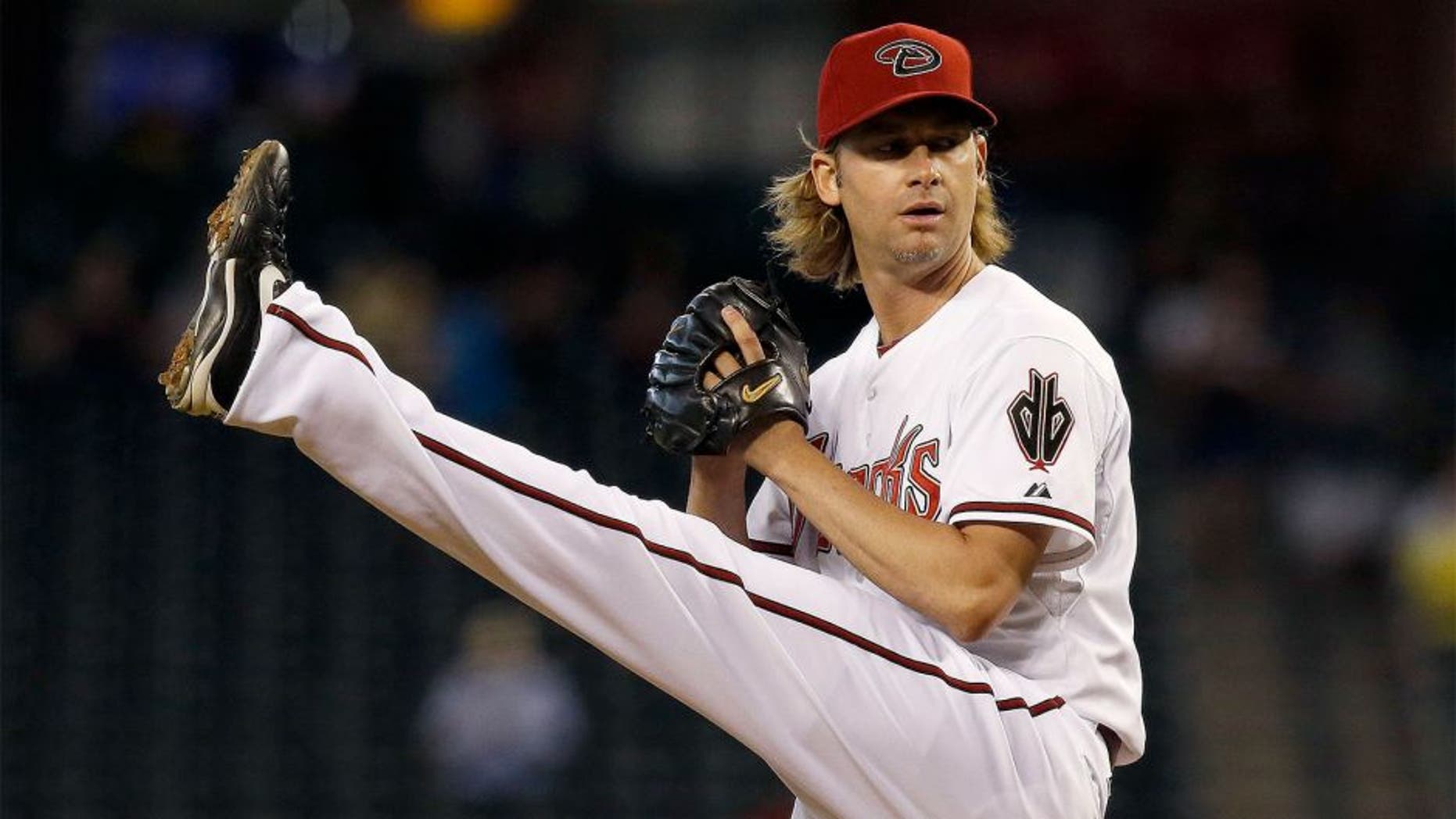 Arizona Diamondbacks' Bronson Arroyo winds up to throw a pitch against the Houston Astros during the first inning of a baseball game on Tuesday, June 10, 2014, in Phoenix. (AP Photo/Ross D. Franklin)