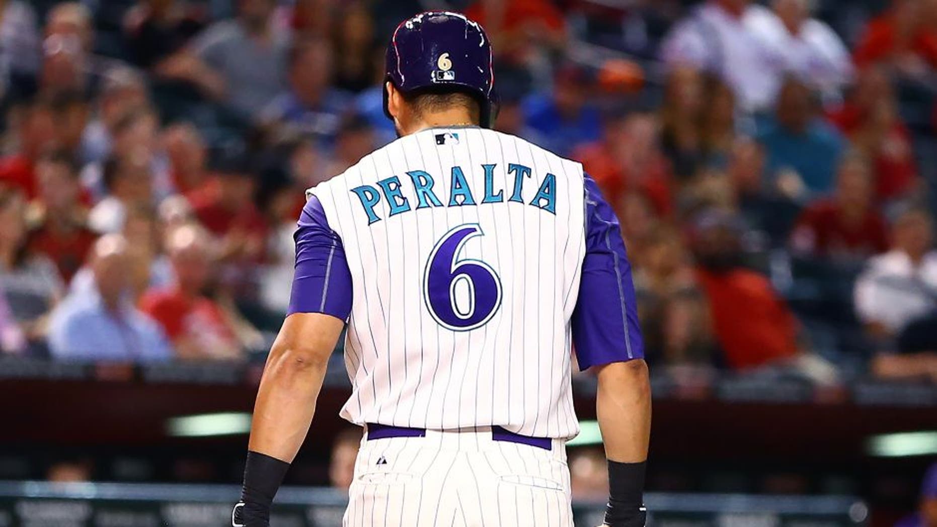 Aug 27, 2015; Phoenix, AZ, USA; Arizona Diamondbacks outfielder David Peralta carries his broken bat to the dugout after striking out and breaking it against the St. Louis Cardinals at Chase Field. Mandatory Credit: Mark J. Rebilas-USA TODAY Sports