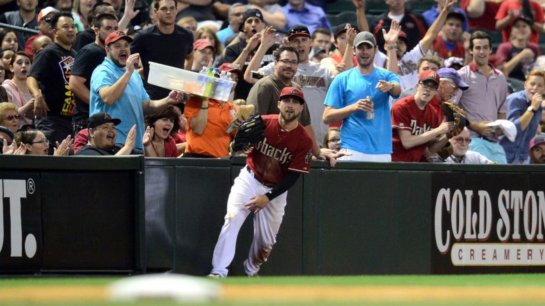 Apr 22, 2015; Phoenix, AZ, USA; Fans react to a sliding catch by Arizona Diamondbacks center fielder Ender Inciarte (5) during the fourth inning against the Texas Rangers at Chase Field. Mandatory Credit: Joe Camporeale-USA TODAY Sports