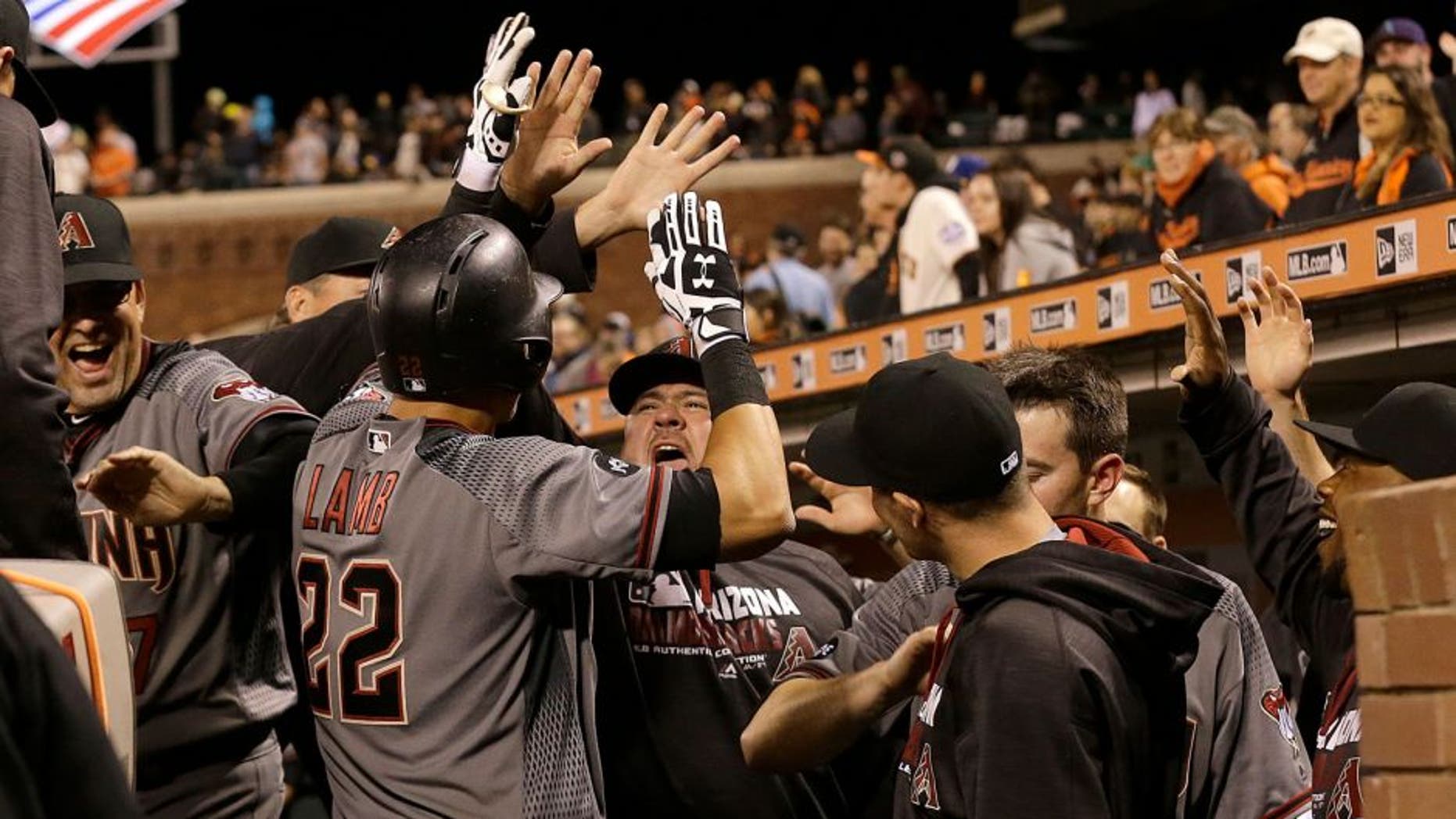 Arizona Diamondbacks' Jake Lamb (22) celebrates with teammates after hitting a solo home run against the San Francisco Giants during the ninth inning of a baseball game in San Francisco, Monday, April 18, 2016. (AP Photo/Jeff Chiu)