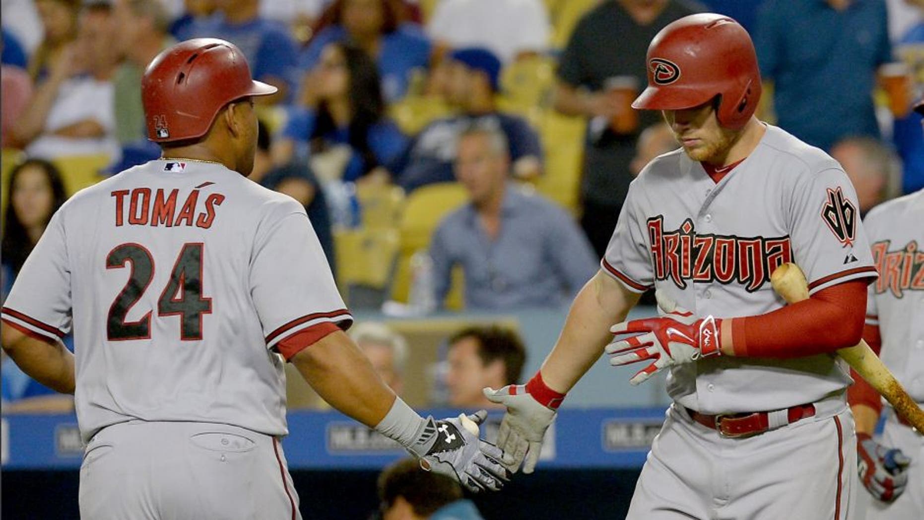 Sep 21, 2015; Los Angeles, CA, USA; Arizona Diamondbacks right fielder Yasmany Tomas (24) is greeted by Arizona Diamondbacks third baseman Brandon Drury (62) after a solo home run in the fourth inning of the game against the Los Angeles Dodgers at Dodger Stadium. Mandatory Credit: Jayne Kamin-Oncea-USA TODAY Sports