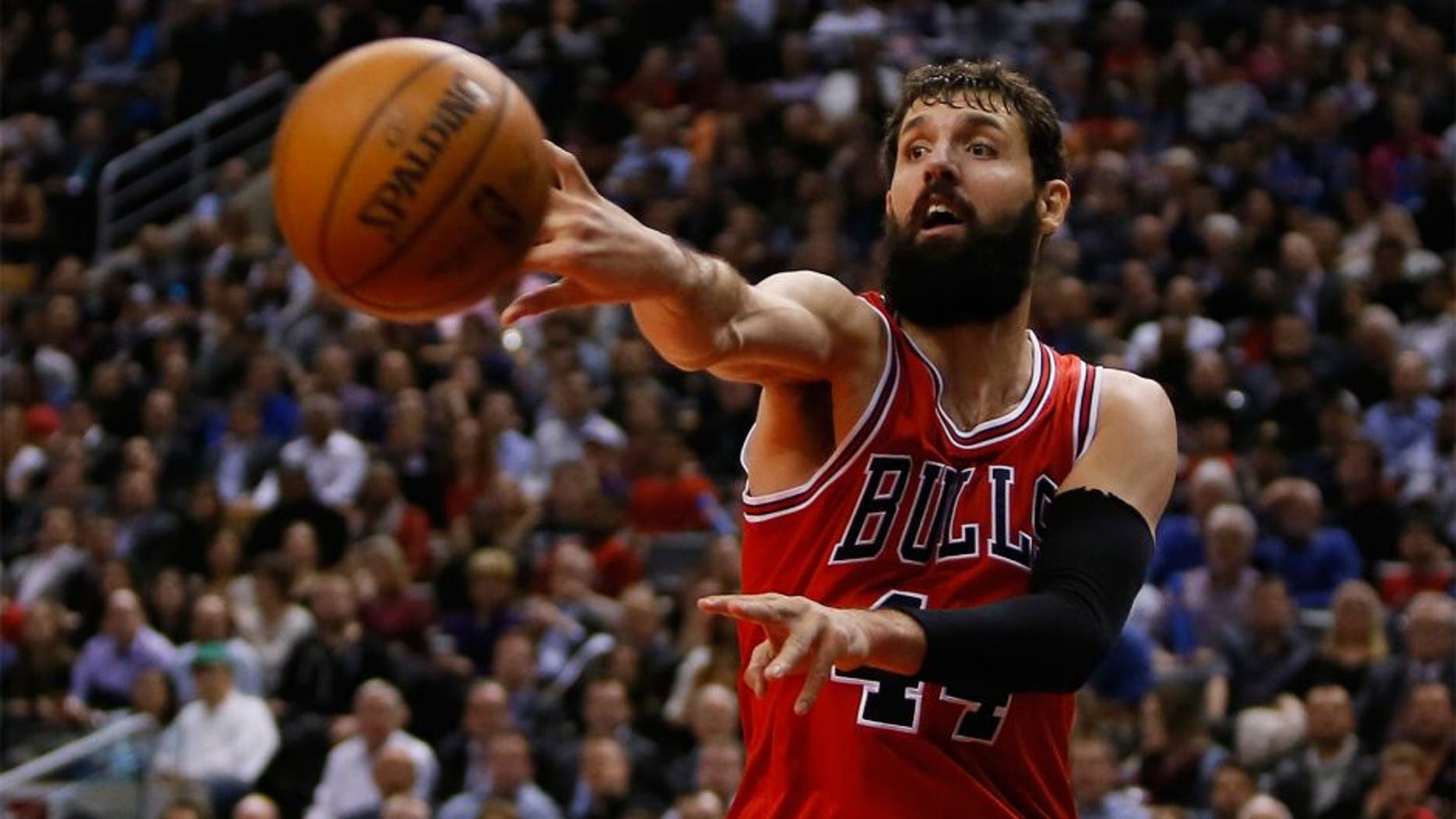Mar 25, 2015; Toronto, Ontario, CAN; Chicago Bulls forward Nikola Mirotic (44) passes the ball against the Toronto Raptors at the Air Canada Centre. Chicago defeated Toronto 116-103. Mandatory Credit: John E. Sokolowski-USA TODAY Sports