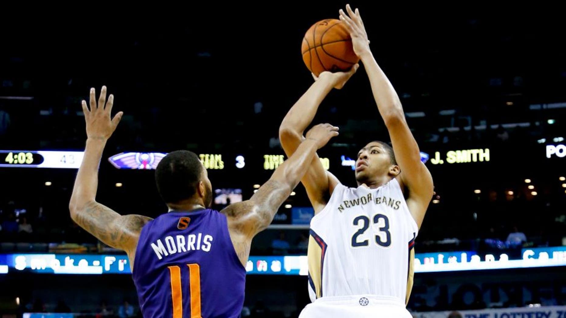 Nov 5, 2013; New Orleans, LA, USA; New Orleans Pelicans power forward Anthony Davis (23) shoots over Phoenix Suns power forward Markieff Morris (11) during the second quarter at New Orleans Arena. Mandatory Credit: Derick E. Hingle-USA TODAY Sports