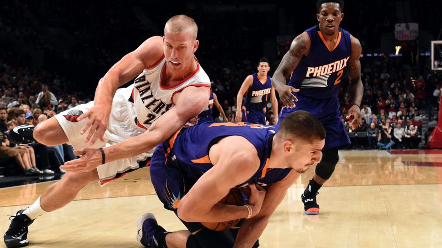 Portland Trail Blazers forward Mason Plumlee dives for the ball with Phoenix Suns center Alex Len during the first quarter of an NBA basketball preseason game in Portland, Ore., Friday, Oct. 7, 2016. (AP Photo/Steve Dykes)