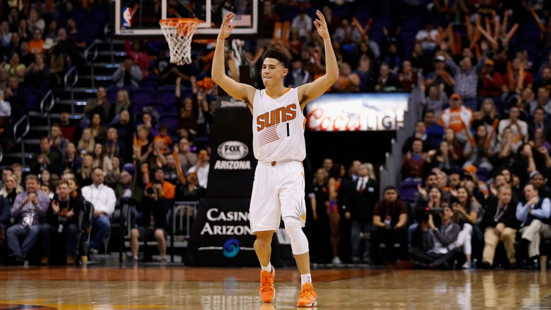 PHOENIX, AZ - JANUARY 06: Devin Booker #1 of the Phoenix Suns reacts after the Suns scored against the Charlotte Hornets during the second half of the NBA game at Talking Stick Resort Arena on January 6, 2016 in Phoenix, Arizona. The Suns defeated the Hornets 111-102. NOTE TO USER: User expressly acknowledges and agrees that, by downloading and or using this photograph, User is consenting to the terms and conditions of the Getty Images License Agreement. (Photo by Christian Petersen/Getty Images)