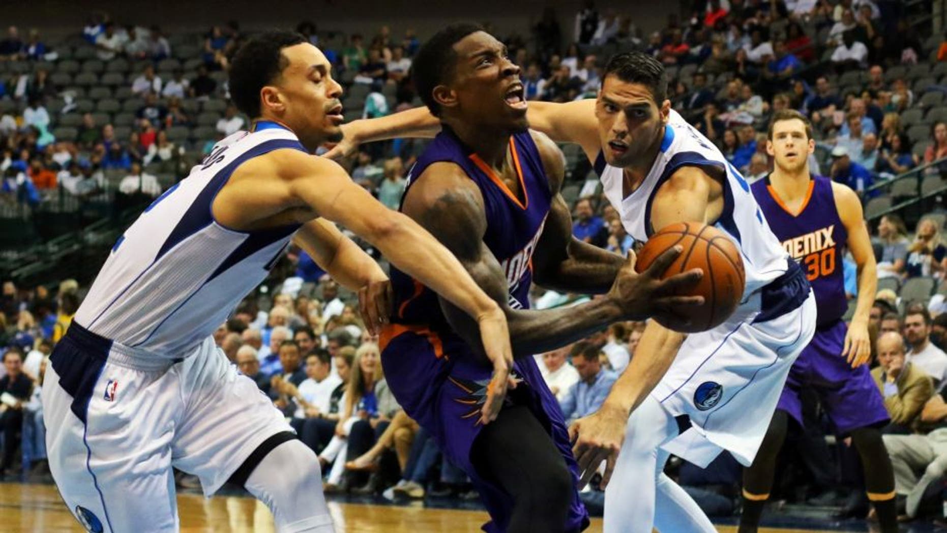 Oct 21, 2015; Dallas, TX, USA; Phoenix Suns guard Eric Bledsoe (2) splits defenders Dallas Mavericks guard John Jenkins (12) and center Salah Mejri (50) during the second half at American Airlines Center. Phoenix won 99-87. Mandatory Credit: Ray Carlin-USA TODAY Sports
