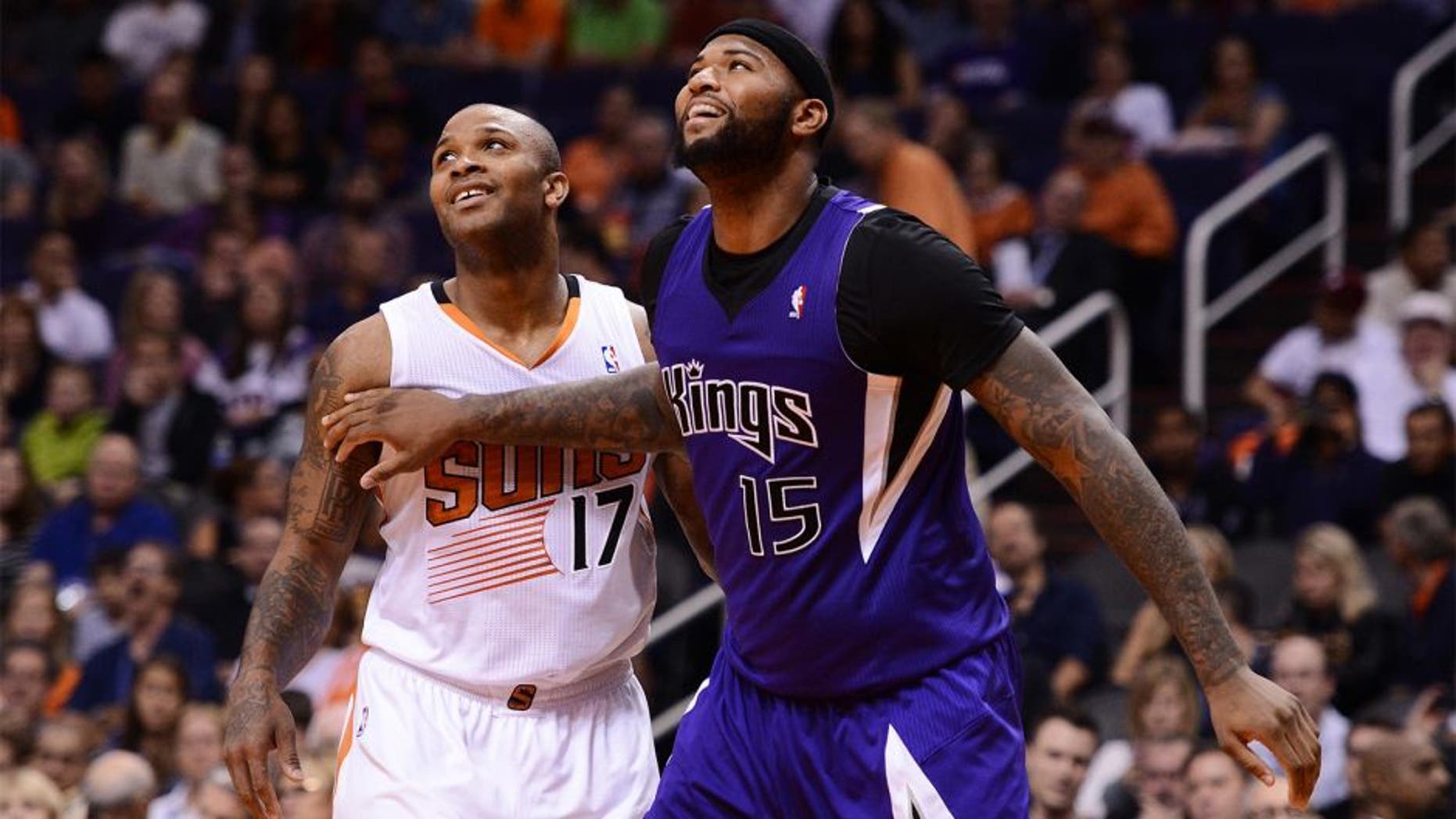 Nov 20, 2013; Phoenix, AZ, USA; Sacramento Kings center DeMarcus Cousins (15) boxes out Phoenix Suns forward P.J Tucker (17) at US Airways Center. The Kings defeated the Suns 113-106. Mandatory Credit: Jennifer Stewart-USA TODAY Sports