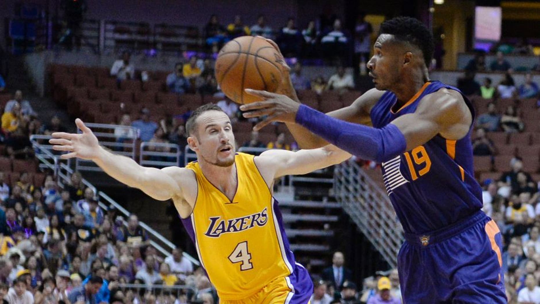 Oct 21, 2016; Anaheim, CA, USA; Phoenix Suns guard Leandro Barbosa (19) passes the ball away from Los Angeles Lakers guard Marcelo Huertas (4) during a preseason NBA game at Honda Center. Mandatory Credit: Richard Mackson-USA TODAY Sports