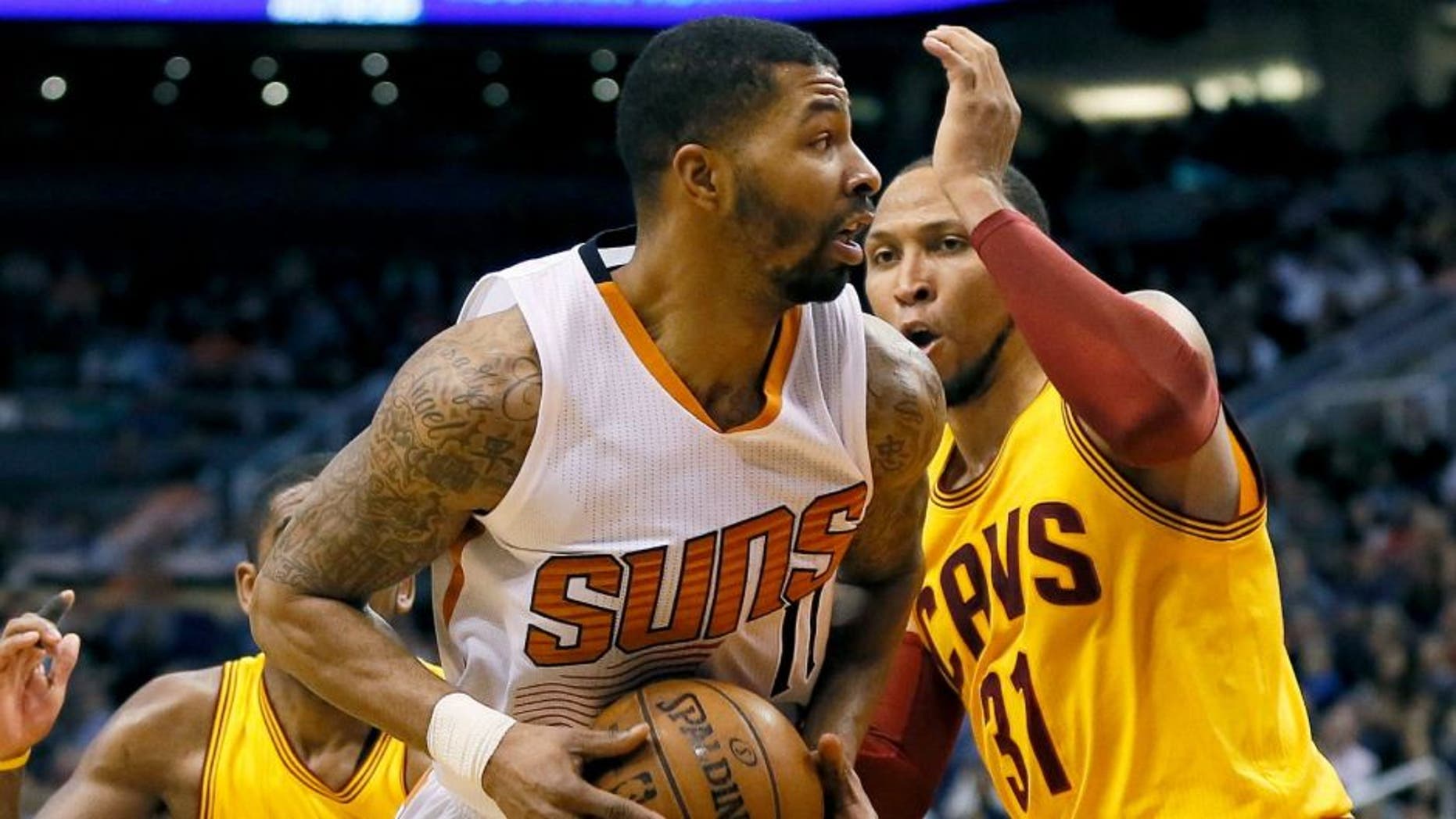 Phoenix Suns' Markieff Morris drives against Cleveland Cavaliers' Shawn Marion during the second half of an NBA basketball game, Tuesday, Jan. 13, 2015, in Phoenix. The Suns won 107-100. (AP Photo/Matt York)