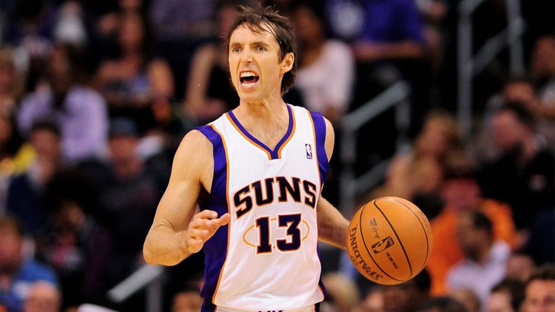 Apr. 16, 2012; Phoenix, AZ, USA; Phoenix Suns guard Steve Nash (13) dribbles the ball up the court while playing against the Portland Trail Blazers during the second half at the US Airways Center. The Suns defeated the Trail Blazers 125-107. Mandatory Credit: Jennifer Stewart-USA TODAY Sports.
