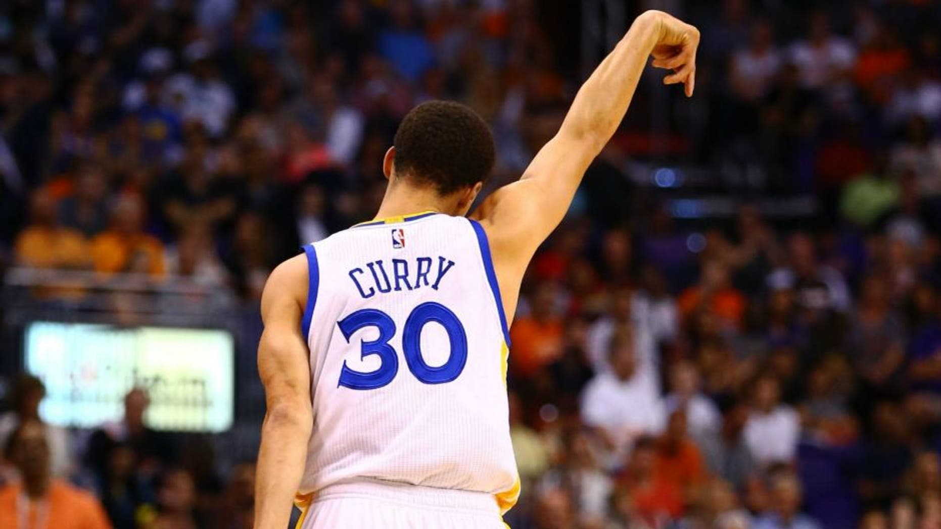 Mar 9, 2015; Phoenix, AZ, USA; Golden State Warriors guard Stephen Curry celebrates a three point shot against the Phoenix Suns in the first quarter at US Airways Center. Mandatory Credit: Mark J. Rebilas-USA TODAY Sports