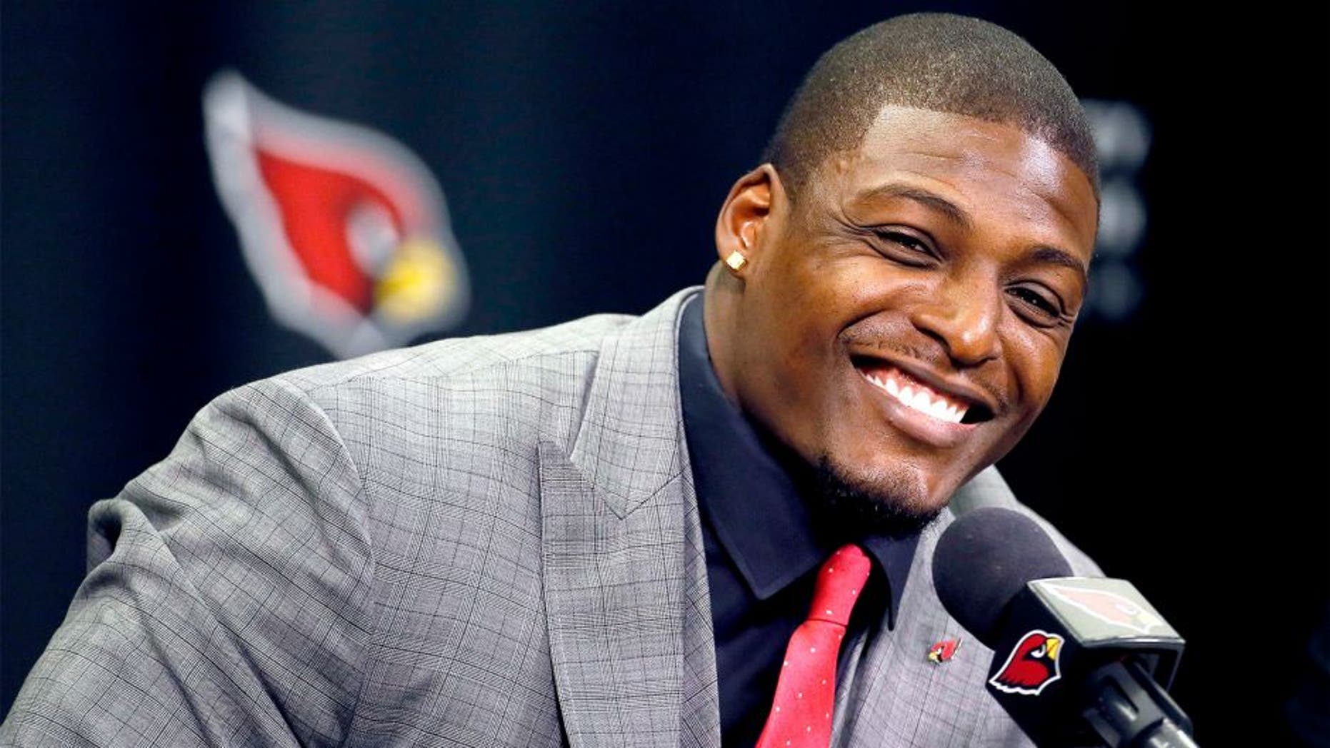 Arizona Cardinals' Adrian Wilson smiles after announcing his retirement, Monday, April 20, 2015, at the Cardinals team facility in Tempe, Ariz. The five-time pro bowler played 12 seasons for the Cardinals. (AP Photo/Matt York)