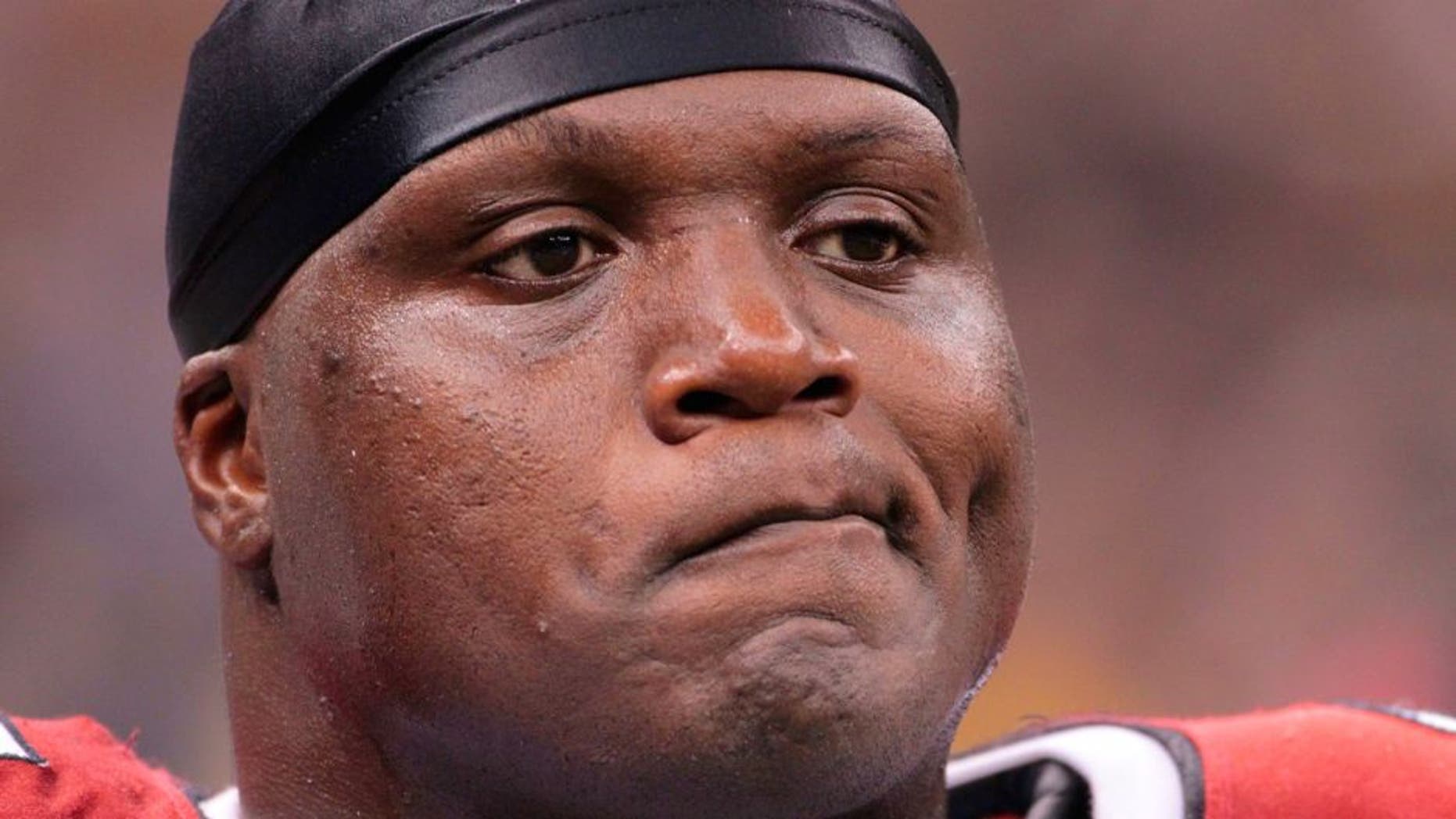 FILE - In this Jan. 16, 2010, file photo, Arizona Cardinals defensive end Bryan Robinson reacts after a New Orleans Saints touchdown during an NFL football divisional playoff game in New Orleans. The Chicago Bears say former defensive lineman Bryan Robinson has died. He was 41. Robinson was found at a Milwaukee motel Saturday night, June 11, 2016. Robinson was with the Bears from 1998 to 2003 and also played for the St. Louis Rams, Miami Dolphins, Cincinnati Bengals and Arizona Cardinals. (AP Photo/Dave Martin, File)