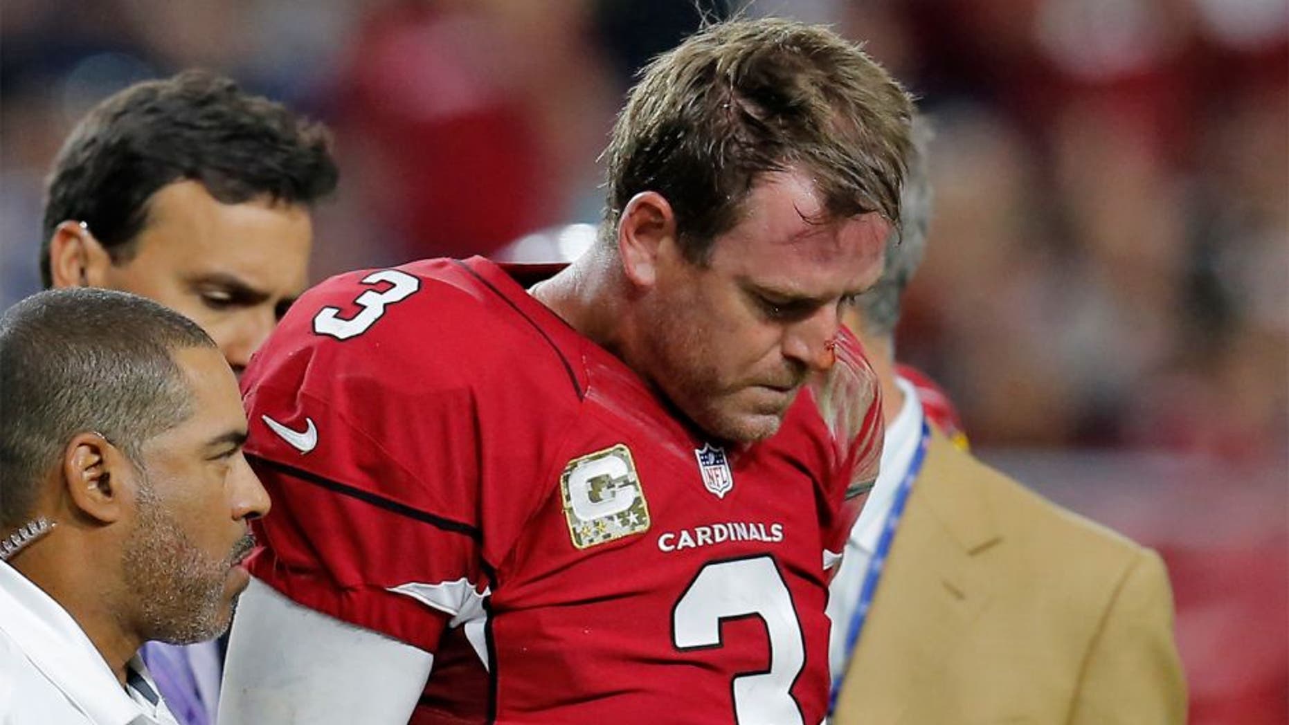 Arizona Cardinals quarterback Carson Palmer (3) leaves after injuring his left knee during the second half of an NFL football game against the St. Louis Rams, Sunday, Nov. 9, 2014, in Glendale, Ariz. (AP Photo/Rick Scuteri)