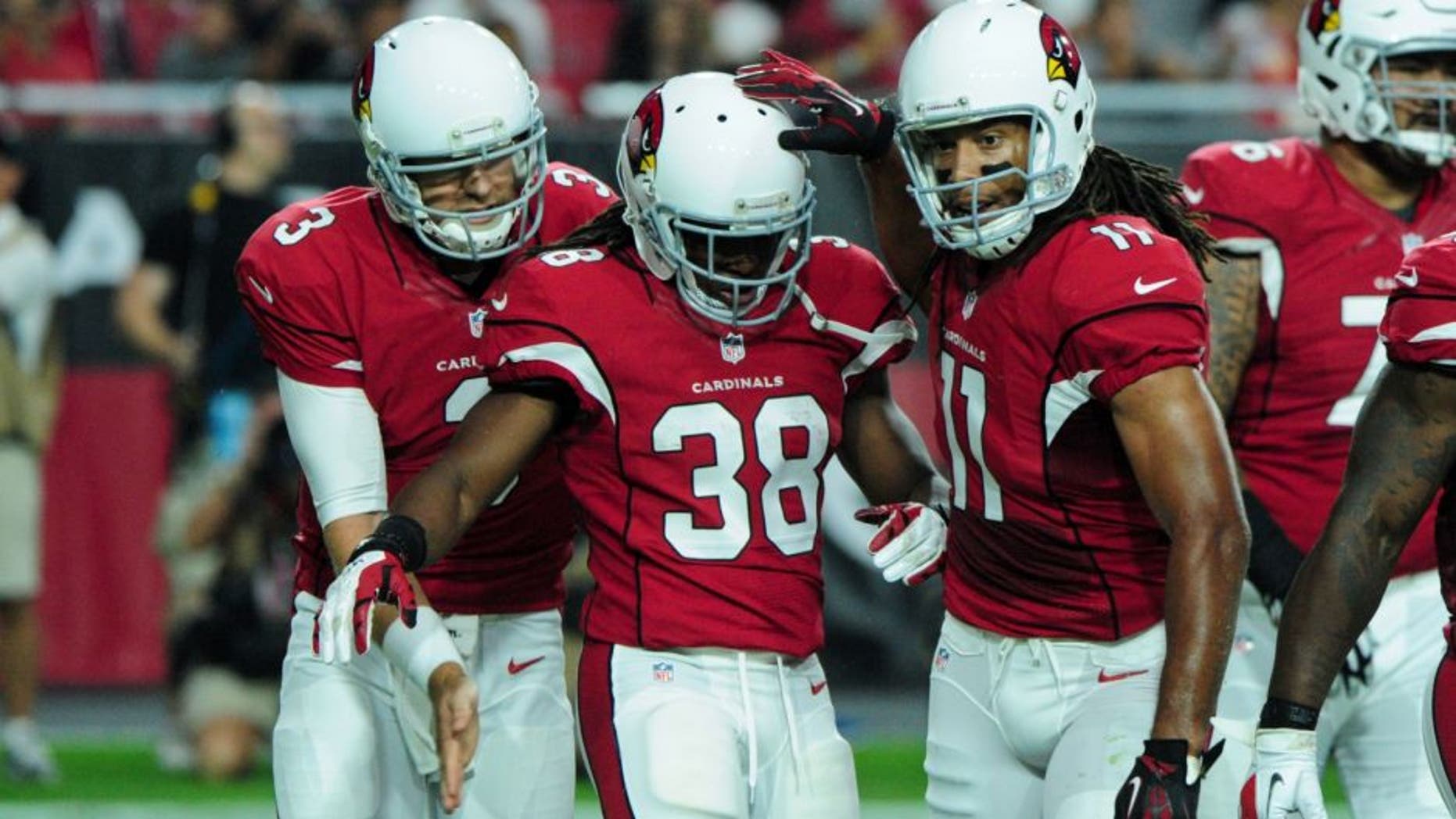 Aug 15, 2015; Glendale, AZ, USA; Arizona Cardinals running back Andre Ellington (38) celebrates with quarterback Carson Palmer (3) and wide receiver Larry Fitzgerald (11) after a 2 yard touchdown during the first half against the Kansas City Chiefs in a preseason NFL football game at University of Phoenix Stadium. Mandatory Credit: Matt Kartozian-USA TODAY Sports