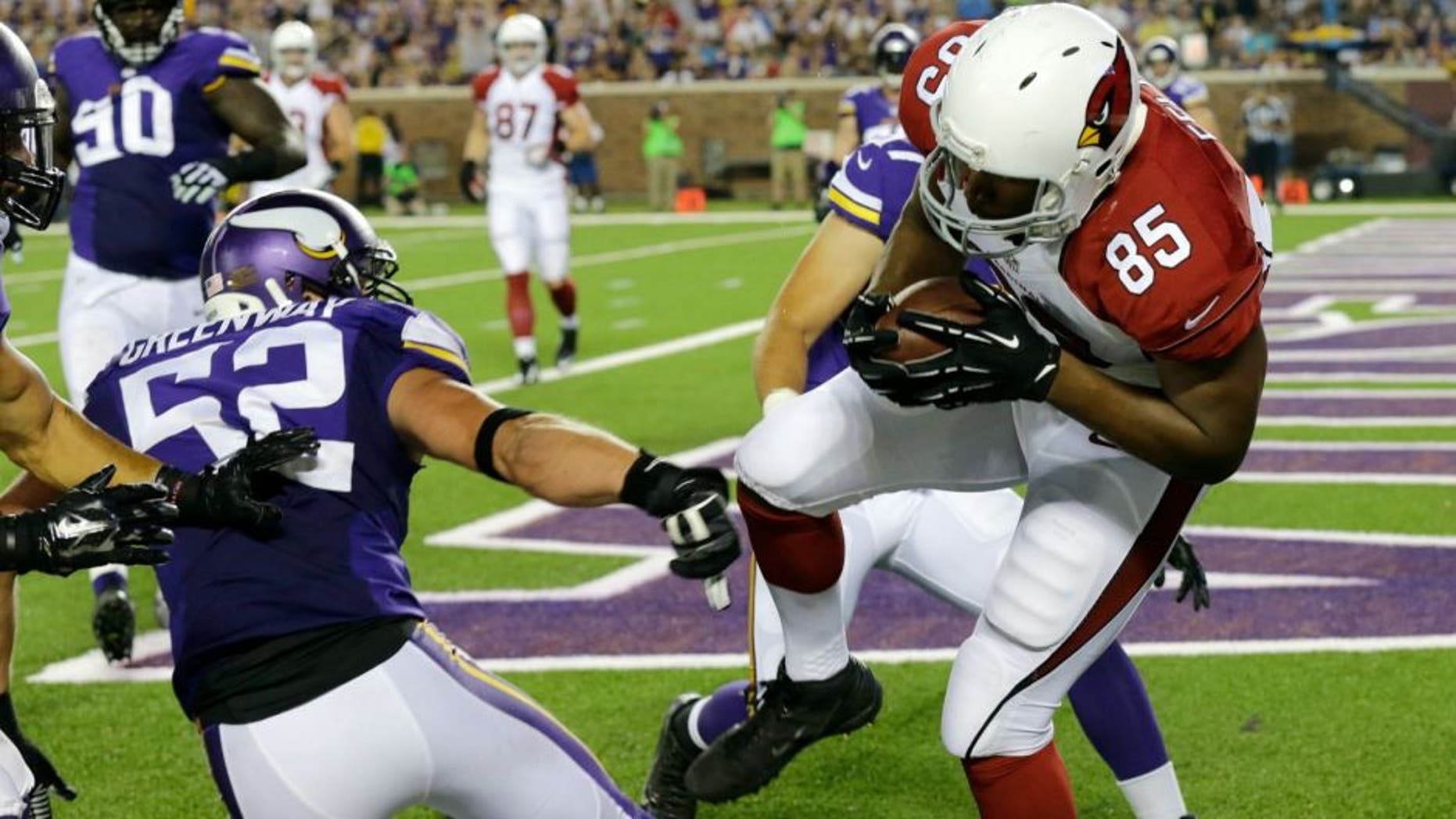 Arizona Cardinals tight end Darren Fells (85) catches a 1-yard touchdown pass in front of Minnesota Vikings outside linebacker Chad Greenway (52) during the first half of an NFL preseason football game, Saturday, Aug. 16, 2014, in Minneapolis. (AP Photo/Ann Heisenfelt)