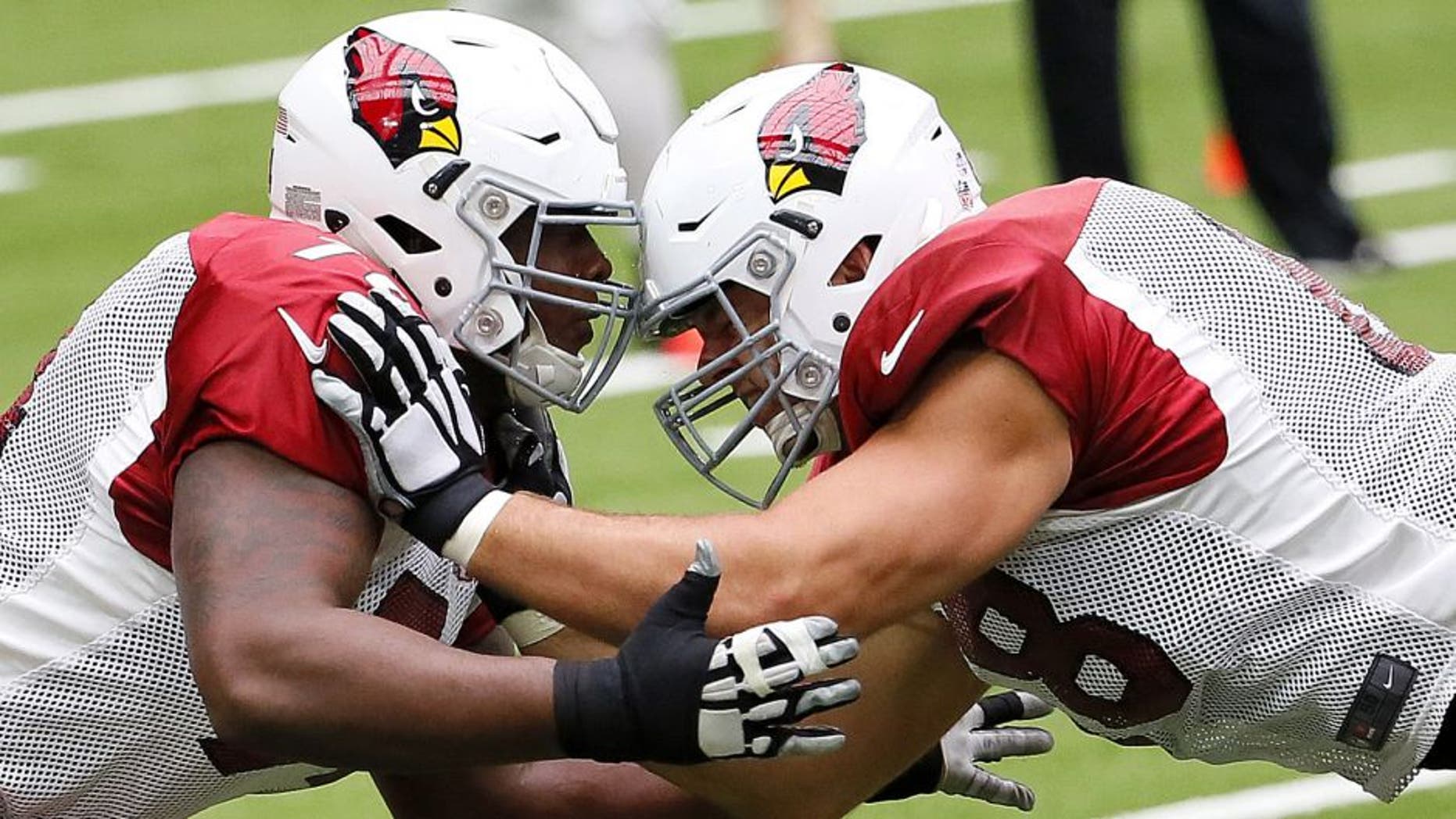 Arizona Cardinals offensive tackle D.J. Humphries (74), left, and tackle Jared Veldheer (68) runs plays during their NFL football camp, Monday, Aug. 24, 2015, in Glendale, Ariz. (AP Photo/Matt York)