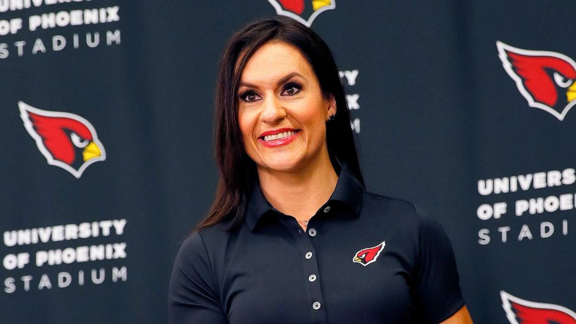Arizona Cardinals training camp football coach Dr. Jen Welter poses for photographers after being introduced, Tuesday, July 28, 2015, at the teams' training facility in Tempe, Ariz. Welter is believed to be the first female to hold a coaching position of any kind in the NFL and will be member of the Cardinals coaching staff throughout training camp and the preseason, working with inside linebackers. (AP Photo/Matt York)