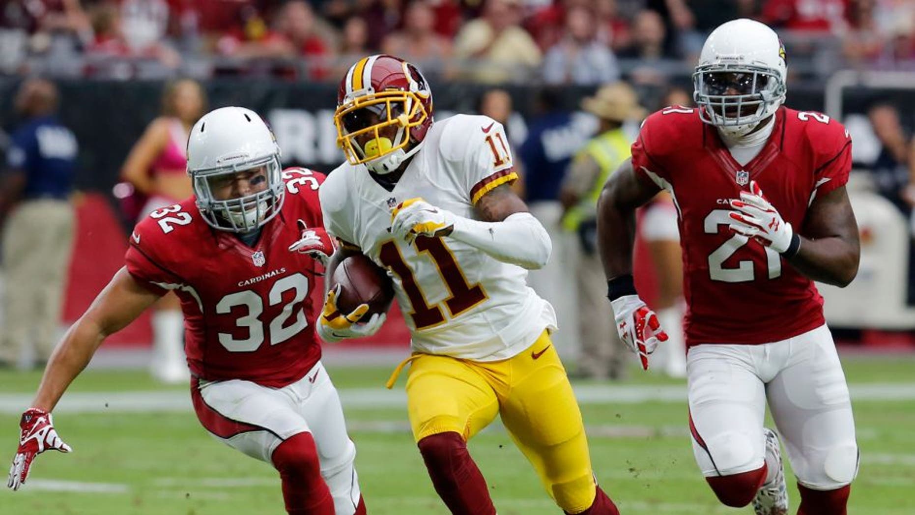 Washington Redskins wide receiver DeSean Jackson (11) runs for a touchdown as Arizona Cardinals free safety Tyrann Mathieu (32) and Patrick Peterson (21) pursue during the first half of an NFL football game, Sunday, Oct. 12, 2014, in Glendale, Ariz.(AP Photo/Rick Scuteri)