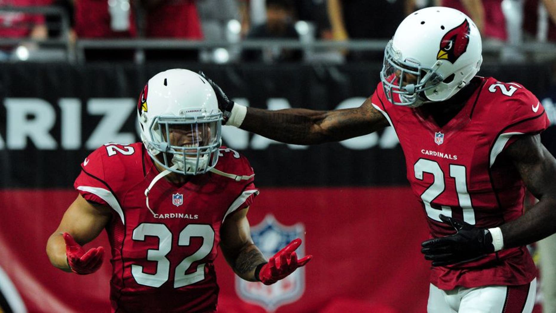 Aug 15, 2015; Glendale, AZ, USA; Arizona Cardinals free safety Tyrann Mathieu (32) celebrates with cornerback Patrick Peterson (21) after a 26 yard interception in the first half against the Kansas City Chiefs in a preseason NFL football game at University of Phoenix Stadium. Mandatory Credit: Matt Kartozian-USA TODAY Sports