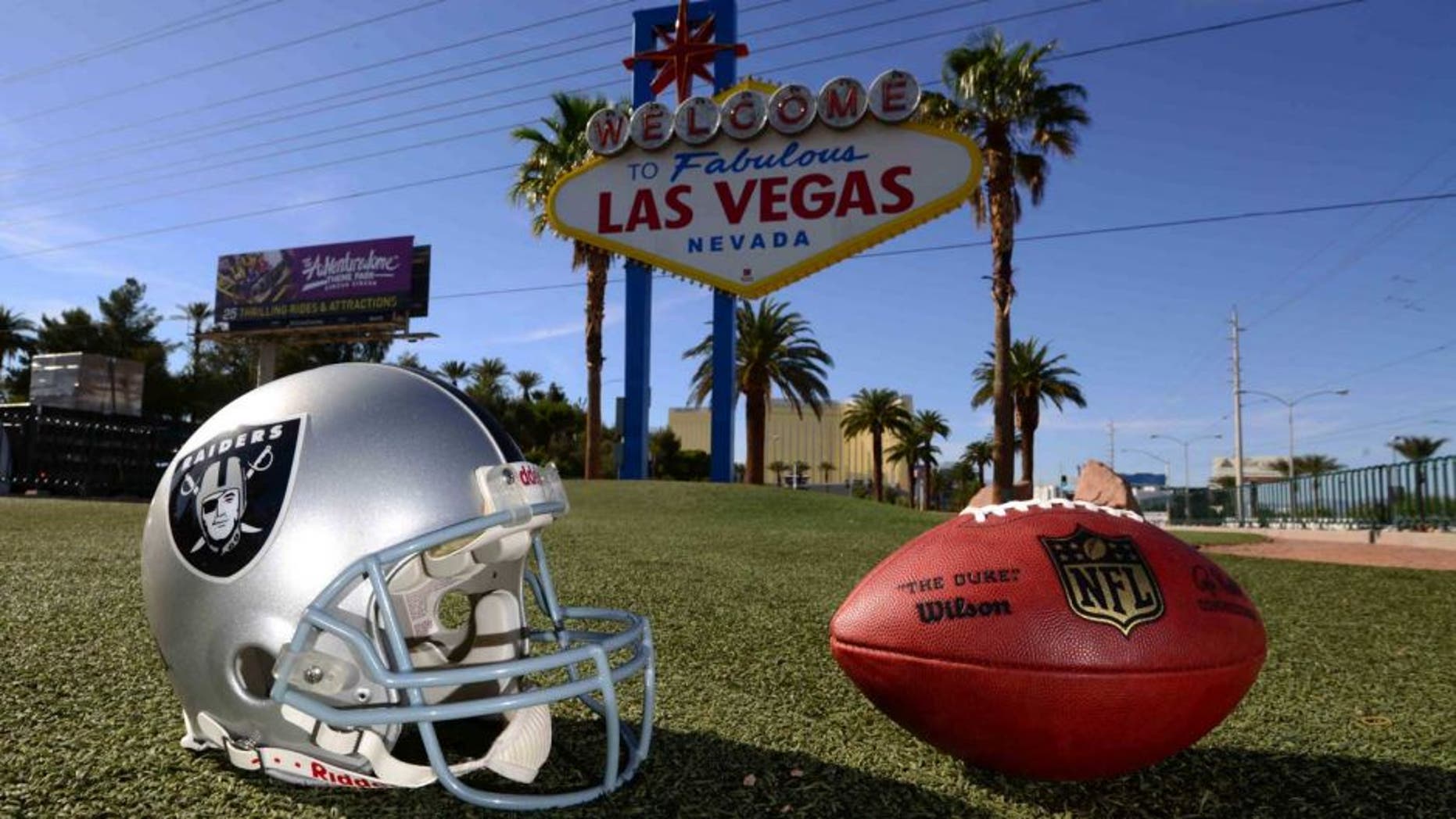 May 11, 2016; Las Vegas, NV, USA; General view of Oakland Raiders helmet and NFL Wilson Duke football at the "Welcome to Fabulous Las Vegas" sign on the Las Vegas strip on Las Vegas Blvd. Raiders owner Mark Davis (not pictured) has pledged $500 million toward building a 65,000-seat domed stadium in Las Vegas at a total cost of $1.4 billion. NFL commissioner Roger Goodell (not pictured) said Davis can explore his options in Las Vegas but would require 24 of 32 owners to approve the move. Mandatory Credit: Kirby Lee-USA TODAY Sports