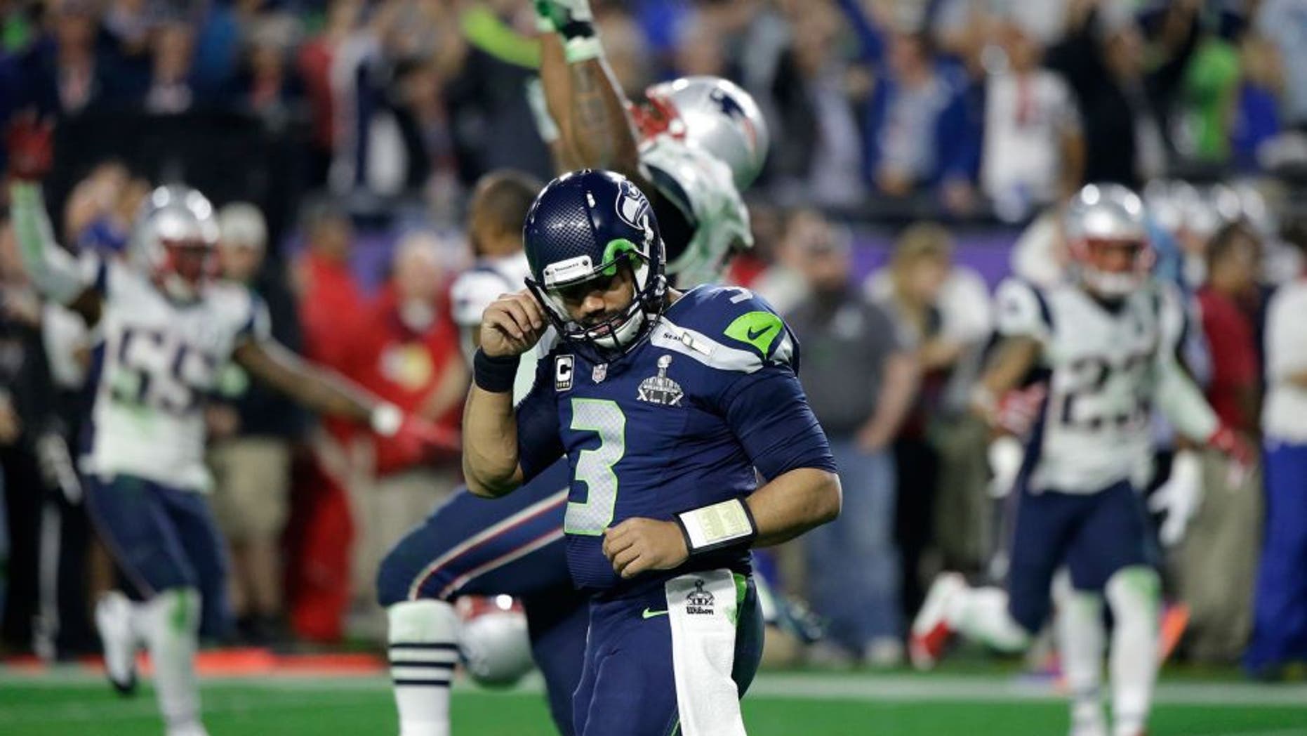 Seattle Seahawks quarterback Russell Wilson (3) reacts after throwing an interception to New England Patriots strong safety Malcolm Butler during the second half of NFL Super Bowl XLIX football game Sunday, Feb. 1, 2015, in Glendale, Ariz. (AP Photo/David Goldman)